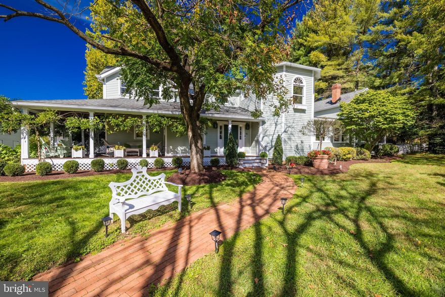 Sanderhill, a captivating, fully fenced equestrian property on nearly 3 1⁄2 acres of level land with gorgeous, mature landscaping, dates to 1804 and has been meticulously updated and expanded.
 
Gracing Great Falls with its unique charm, the lovingly restored antique farmhouse leans into its traditional architecture and historic roots while boasting a contemporary and inviting floor plan, fresh paint and lighting and renovated bathrooms throughout. An inviting private boulevard driveway lined with lovely mature Kwanzan Cherry trees leads to a pretty wraparound porch. The wide farmhouse front door opens up to a spacious foyer and branches off to the main level Primary Suite on one side, and the formal dining room on the other. The centerpiece is a two-story Great Room with beautiful natural light and a grand fireplace and a gourmet marble island Kitchen with cathedral ceiling, ample cabinetry, new appliances and a central island.
The main level is a testament to comfortable luxury living, featuring a Primary Suite with screened porch and exquisitely updated marble bathroom.  The main level also includes a guest bedroom and bathroom and a second screened porch. The upper levels of Sanderhill continue to impress with hardwood flooring and loft sitting spaces with built-ins and plenty of natural light. Bedrooms feature unique architectural details like cathedral gable ceilings, reclaimed wooden beams, plantation shutters and window seats.

The lower level features a spacious Rec Room, complete with a sauna and a wet bar, Media Area and a separate Play/Exercise Room.

The rear flagstone patio and storybook landscaping enhance the property's allure. The surrounding acreage is graced by towering trees, an operating equestrian Barn, a detached three-car garage and a former ice house, easily convertible to an office or playhouse.

With its prime location near Great Falls Village, this property on 3.367 acres offers not only a spacious and comfortable interior but also lovely curb appeal. Sanderhill is conveniently located near prestigious schools and offers easy access to shopping, dining, and entertainment in Great Falls Village, McLean, Tysons Corner, and beyond. Major commuting routes, Dulles and Reagan National airports, and the Dulles Technology Corridor are also within reach. Sanderhill embodies the perfect blend of historic elegance and modern luxury.