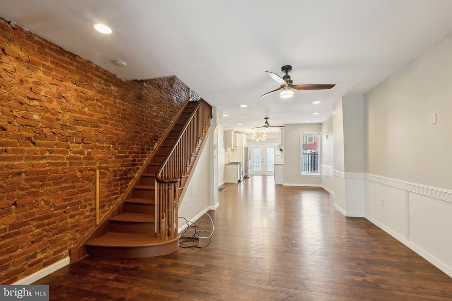 Welcome to 5328 Master Street, a beautifully finished rental property in the desirable Carroll Park section of Philadelphia. This home blends classic charm with modern updates, starting with a stunning entry vestibule featuring custom barn doors. Highlights include gleaming hardwood floors and an exposed brick accent wall. The chef’s kitchen has stainless steel Samsung appliances, granite countertops, and stylish cabinetry. Through the kitchen, step outside to a generously sized rear patio that overlooks a private parking area for up to two vehicles. The finished basement features plush carpeting and a convenient half bath. Upstairs, you’ll find three spacious bedrooms and a beautifully appointed full bathroom complete with wainscoting and a high-end TOTO smart toilet. Located within walking distance of Park West Town Center, you'll have easy access to shopping, dining, and daily essentials. Public transportation, including the trolley line, is also nearby. Tenant pays $50 flat fee for water.