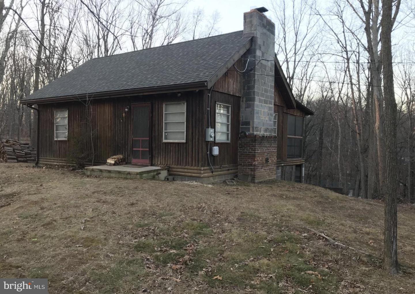 Charming cabin on a half acre. One bedroom and one bathroom with additional living space in a loft overlooking the great room. This cozy home features a brick fireplace, with log walls and hardwood floors throughout. There is also a large screened porch overlooking the private, wooded back yard. The large basement provides extra storage or a nice workshop!