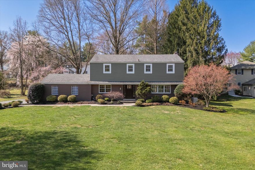 Nestled within a prestigious Radnor neighborhood, this elegant 4-BR, 2.5-BA colonial offers timeless charm w/ modern updates. Situated on a sprawling 0.76-acre lot, this home boasts over 2,268 sq feet of above grade thoughtfully designed living space, blending refined craftsmanship w/ everyday comfort. Step into the gracious foyer w/ tile flooring & enjoy the inviting ambiance. Setting the tone for the rest of the home are the beautiful HW floors which extend nearly throughout the whole home. Enter the private home office w/ French doors & recessed lighting, which provides a peaceful workspace. The formal dining room—anchored by a stunning triple window overlooking the front yard—flows seamlessly into the family room through stately double columns. Easily enjoy intimate gatherings by the wood burning fireplace w/ tile surround after a delightful dinner all in this great space! Through the sliding glass doors, a flagstone patio provides the perfect setting for entertaining, overlooking the beautifully landscaped backyard. The heart of the home is the full eat-in, gourmet style kitchen, beautifully appointed w/ cherry cabinetry featuring premium molding, Corian quartz countertops, & a ceramic tile backsplash w/ an intricate accent design. The home chef will be inspired by the SS appliances, built-in 5-burner electric range, a custom SS range hood & built-in pantry. Bonus seating for 3 at the breakfast bar makes this space as functional as it is stylish. Recessed lights & murano glass pendants, as well as picturesque views of the backyard add to all the charm. Rounding off the main level is a convenient mudroom & laundry area, equipped w/ built-in storage bench seating & side yard/garage access, add to the home’s practicality. Upstairs, the grand primary suite serves as a true retreat w/ dual custom closets & a beautifully renovated ensuite BA. The spa-inspired design features a dual vanity w/ premium HW cabinetry & granite countertops, spectacular stone flooring, built-in storage cabinets w/ elegant accent shelving, a glass-door shower w/ stone tile walls & pebble flooring. Three additional BR’s offer ample lighting, ceiling fans, & generous closet space. A stylishly updated hallway BA completes this floor, featuring classic tile floors & a jetted tub-shower combination. The finished basement offers additional living space w/ recessed lighting & a flexible bonus room. This meticulously maintained home includes a 22KW full-home Generac generator (2020), new roof shingles & exterior siding (2013-2014), & an updated HVAC system w/ gas furnace & heat pump (2011). Other notable upgrades include an Anderson patio door (2004), a commanding Therma-Tru front door (2013), & a repaved driveway (2021). Located in Radnor Twp, this quiet community offers the perfect blend of suburban tranquility & city convenience. Just minutes from Main Line shopping, dining & regional rail stations, this property is an exceptional find in one of the area’s most sought-after neighborhoods. Make this gorgeous estate your home! Schedule today!