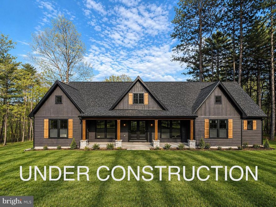 Fall delivery! Welcome to this beautifully designed 4-bedroom, 3.5-bath home offering the perfect blend of comfort, functionality, and modern living. With a spacious and thoughtfully laid-out floor plan, this home is ideal for both everyday living and entertaining. Step onto the inviting front porch and into a welcoming foyer that opens into a large great room with a cozy gas fireplace. The open-concept design flows seamlessly into the kitchen, featuring a large center island, Quartz countertops throughout, and a stainless steel kitchen appliance package, walk-in pantry, and adjacent dining area—perfect for gatherings. The private primary suite is tucked away on one side of the home, offering a peaceful retreat with vaulted ceilings, a luxurious en-suite bath with soaking tub, separate shower, dual vanities, and generous his-and-her walk-in closets. On the opposite side, you’ll find two additional bedrooms and a full bath, providing plenty of space for family or guests. Practical features abound, including a mudroom with drop-off bench, a dedicated laundry room, a dedicated office complete with built-ins, and a convenient powder bath. Upstairs, the loft provides an additional bedroom and bathroom. Enjoy outdoor living year-round with a three-season sunroom finished and heated —perfect for entertaining or relaxing evenings at home. Minutes to Cacapon Resort State Park where residents can enjoy access to golf, dining, walking trails or visit downtown Berkeley Springs and more. Don’t miss your chance to make this incredible new home yours! Under Construction close to Cacapon State Park & amenities. "Please note: The photos shown are of a similar completed home. The specific home may vary in floor plan, finishes, or upgrades. The builder reserves the right to substitute materials that may not be available to avoid delays."