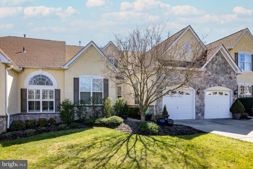 Welcome to 92 McConkey Drive.  This carriage home located in desirable Traditions at Washington Crossing is a showstopper. The home boasts hardwood floors, an updated kitchen, and bathrooms.  When you enter the house, you are greeted with a grand foyer that brings you into the eat-in kitchen or past to the large dining room area.  Head into the living room to cozy up to the gas fireplace and relax. Past the fireplace is the bright sunroom with loads of natural light. Off the sunroom is the large deck that backs up to the woods to give even more privacy.  The primary and secondary bedrooms and bathrooms round out the first floor. Upstairs is the loft area that can be an office, bedroom, or even more storage. The downstairs has been finished to include a large kitchenette and bathroom, perfect for entertaining.  There are so many amenities on the property as well including Tennis and Bocce courts, the clubhouse with its fitness center, walking trails, a library, indoor and outdoor pools, and a game room.  You will want to be a part of this vibrant community.  Don't miss this home!