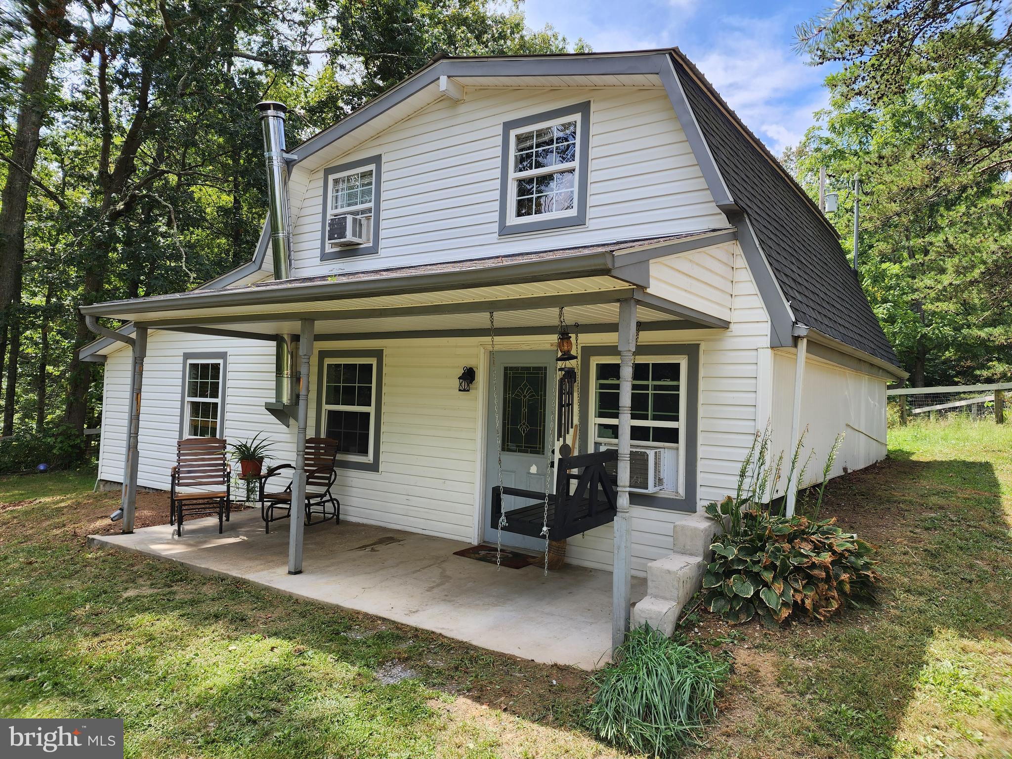 CUTE AS CAN BE BUNGALOW, SECLUDED SETTING & SURROUNDED BY NATURE. FULL FRONT PORCH, OAK KITCHEN WITH APPLIANCES, LIVING ROOM WITH WOODSTOVE, MAIN LEVEL MASTER BEDROOM & BATH. MAIN LEVEL LAUNDRY, NEWER WASHER & DRYER (BOTH STAY.) UPSTAIRS HAS 2 BEDROOMS AND SECOND FULL BATH, SMALL REAR BALCONY....SWEET. NEW CULLIGAN WATER SOFTENER IN 2022 ($3,500). PUBLIC WATER (WELL CAPPED & NOT USED). JUST 10 MIN FROM I-81 AND 15 MIN TO HAGERSTOWN AND/OR MARTINSBURG. SO NICE TO COME HOME TO!