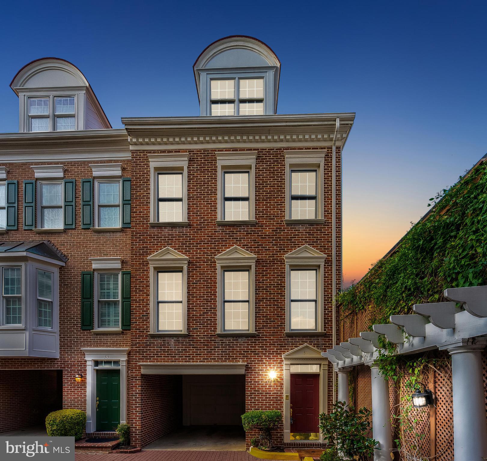 Welcome to 311 Hearthstone Mews, a stunning four-level end unit townhouse located in the charming heart of Old Town, Alexandria, just a block from the serene Potomac River. This elegant home features three spacious bedrooms and three and a half beautifully appointed bathrooms, covering approximately 2,049 square feet of refined living space.
As you enter, you'll be greeted by an atmosphere of sophisticated comfort, with high ceilings, crown moldings, and newly refinished hardwood floors throughout. The home has been freshly painted, enhancing its modern allure. The living room, centered around a warm, inviting fireplace, is perfect for cozy gatherings. Culinary enthusiasts will adore the open kitchen, complete with granite countertops, mosaic backsplash tiles, stainless steel appliances, and a brand-new stove. Sunlight streams through the two floor-to-ceiling white French doors, illuminating the space.
The bathrooms have been tastefully renovated, adding a touch of contemporary elegance. Retreat to the primary suite, a private sanctuary featuring a spacious bathroom with separate tub and shower, dual sinks, and a generous walk-in closet.
Relax on your private patio with a morning coffee or enjoy a sunset glass of wine on the exclusive rooftop deck, offering stunning views. Additional features include a new water heater, new carpeting, a convenient in-home washer and dryer, and efficient air conditioning. An attached garage provides added convenience and security. Situated in a highly sought-after neighborhood, this home is just steps away from scenic bike paths and the vibrant energy of King Street's restaurants and shops.