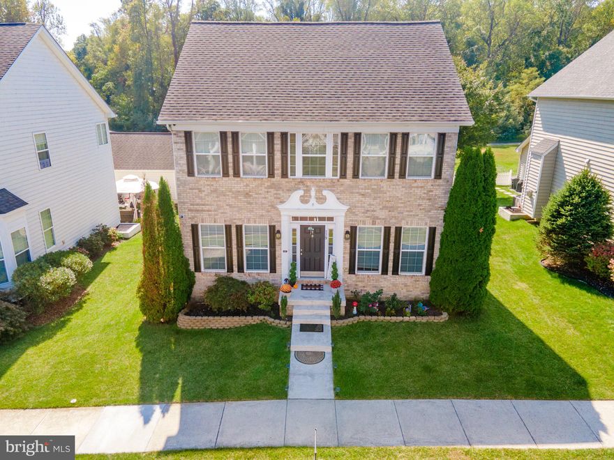 PRICE REDUCED!!! Beautiful brick front colonial in lovely Huntfield S/D.  Offering 3+BR/3.5 BA, work from home in the now office/library with custom built-in bookcases with LED lights, formal dining room, sun filled eat-in kitchen with island and family room with gas fireplace. Primary bedroom has vaulted ceilings, walk-in closet and full bath with garden tub, separate shower and a double vanity.  Basement is finished into a den, full bath and spacious rec. room. 9' ceilings on first floor, granite counter tops, recessed lighting, stainless steel appliances, wood floors throughout the main level, 50 AMP generator hook up for power loss, 8 security cameras and recorder included with alarm sensors on all windows and doors and so much more. Even 50 AMP 220 to the two-car garage with CAT 5 wires. Two great outdoor sitting areas, one fireplace area and one pergola area to enjoy this fall weather. Roof, siding and gutters were replaced just a couple of years ago.   Couch and loveseat will convey in basement.  TV(s), TV wall mounts will be removed and patched/painted prior to settlement.  Nearby playground and tennis courts. Ideal for commuters!