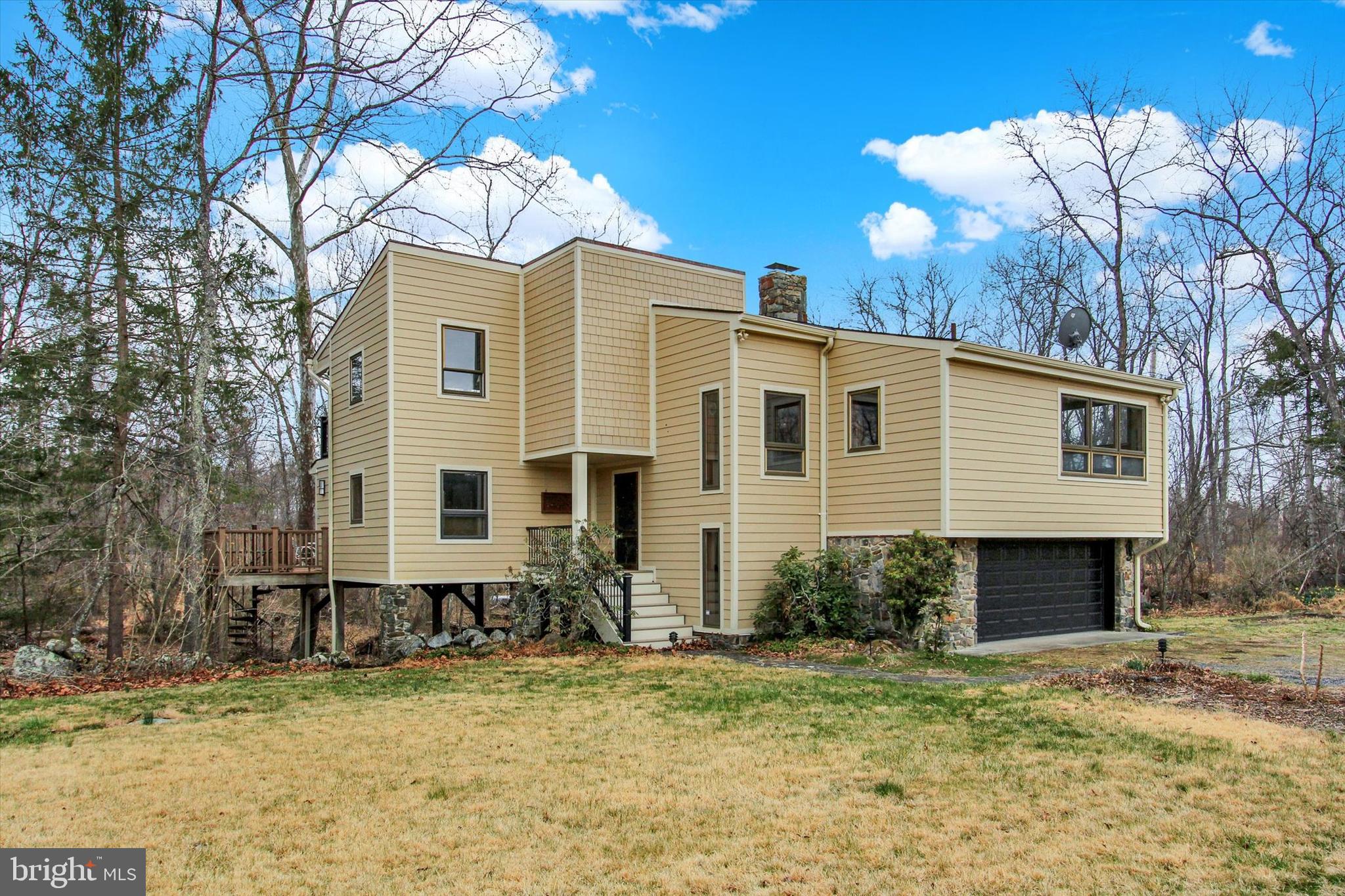 Paradise in the form of rare and stunning 119 secluded, mostly wooded acres with Middle Creek running right through it. All this just 13 minutes from historic downtown Gettysburg Square. One huge stocked pond and second smaller pond. Walking paths all through the woods to spy deer galore! Large barn, for horses maybe? New Hardie board siding, new roof and composite upper and lower decks overlooking Middle Creek just start to cover the amazing house features. Inside you will find views of the creek from extra large windows in most rooms of the house. Hardwood floors and real wood features through-out. The great room features vaulted ceiling with floor to ceiling, wall-to-wall stone-front wood-burning fireplace. Just off the great room is a sunroom where you are essentially surrounded by the creek. 2 primary bedrooms offer choices for the owner. One owner's suite with full bath is on the 1st floor and the other owner's suite with full bath is on the 3rd level. Both overlook the creek of course. Open wood stairs lend an airyness to the house as you make your way to the 2nd and 3rd levels. The second level features 2 bedrooms and a full bath. Open loop geothermal heating system for house and separate gas heater in garage. Diesel generator conveys. Most of the property is zoned rural conservation, but a few acres that run to Bullfrog Rd is zoned Commercial Corridor: Perfect if you are thinking about combining your home with a commercial venture on the same property. Come take a look and feel your blood pressure lower the second you enter the driveway!