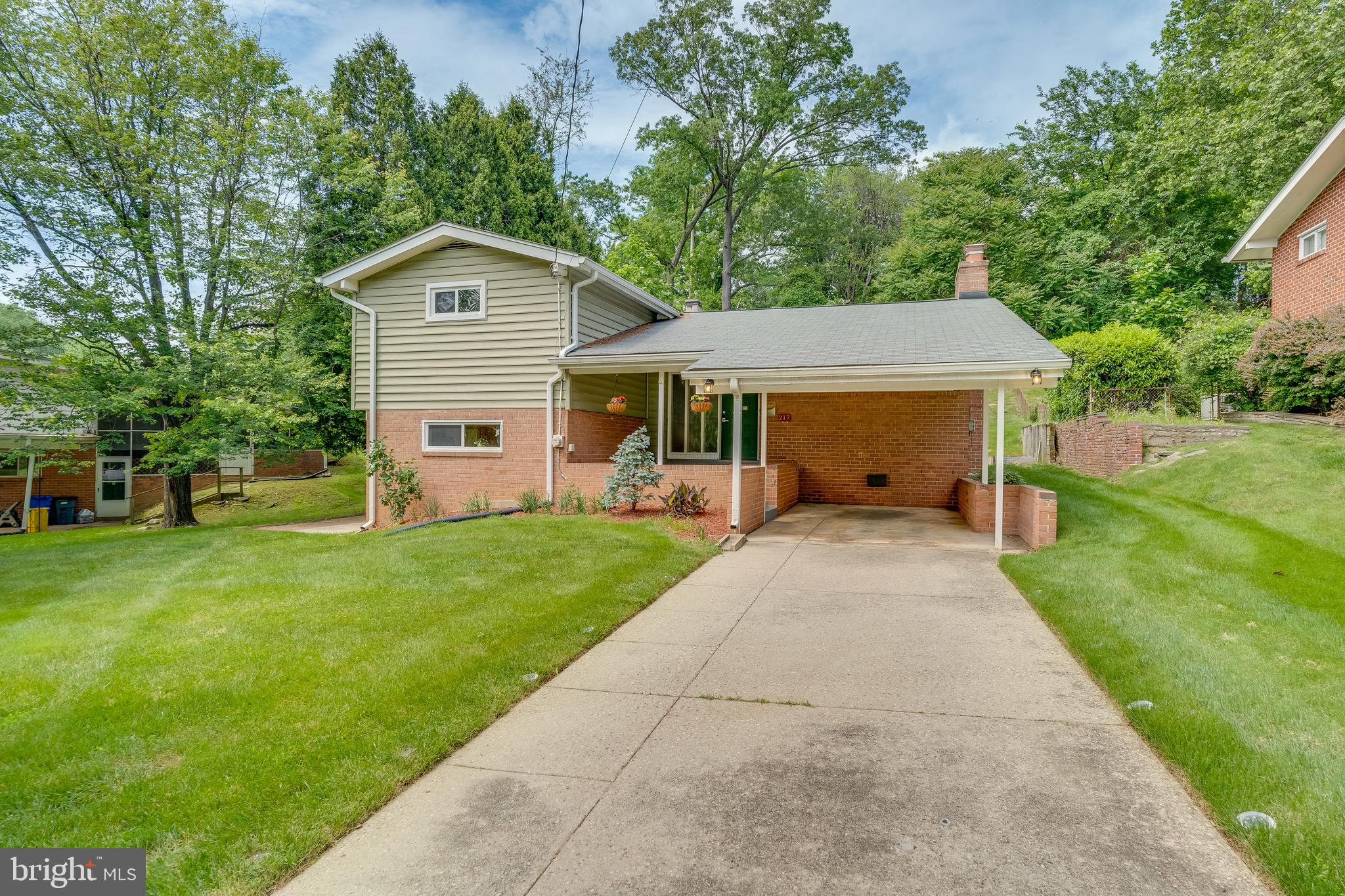 Welcome to 217 Hillsboro Drive, a charming 4-bedroom, 2.5-bathroom home in the heart of Silver Spring, MD. This spacious split-level residence boasts almost 2,500 square feet of living space and sits on a generous .23-acre lot, providing ample room for indoor and outdoor activities. As you step inside, you're greeted by a welcoming foyer leading to a thoughtfully designed interior that seamlessly combines modern elegance with comfortable living. The living room is highlighted with a cathedral ceiling, creating a sense of openness and grandeur within the home. Cozy up to two fireplaces on separate levels, adding warmth and character to the home. The kitchen is a focal point of the home, offering a spacious layout with attached eating space and plenty of cabinet and pantry space, providing an ideal setting for culinary creativity and gatherings with loved ones. Off the kitchen is the laundry/mudroom with separate access to the outside. The home was updated in 2021 with modern finishes, including sand/refinished wood floors, bathroom finishes, and lighting fixtures, offering a touch of sophistication to the living areas. The utility room offers ample storage space, seamlessly integrating organization and functionality into the home. Additionally, the new washer/dryer (2023) and water heater (2020) provide added convenience and efficiency for everyday living. The HVAC system and the Roof (2015/2016) were recently replaced (2015/2016). Outside, the property provides a tranquil retreat with plenty of space to relax and entertain, making it perfect for enjoying outdoor activities and creating unforgettable memories with family and friends. A one-car carport and covered front patio round out this spectacular property.