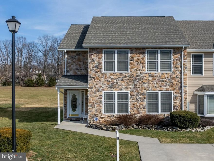 Immaculate & well cared for " EXTRA WIDE " END UNIT townhome with a gorgeous stone front.  You can now own your own home backing to Locust Hill Golf Course. The extra width truly makes this townhome feel like a single family home! Sip your coffee in the morning from your front porch or covered back porch and enjoy the nature and open space the golf course provides. This beautifully maintained home boasts real hardwood & ceramic floors, new heat pump and air handler since August 2022, an updated kitchen, and upgraded appliances with  great views of the golf course from your kitchen! The main level bathroom is made with marble tile. This open and spacious floor plan has a HUGE eat in kitchen that takes you to your private covered oasis/rear patio equipped with a ceiling fan and extra storage shed connected to house. *All showings must be by appointment & buyers must have a loan pre-approval prior to showing.