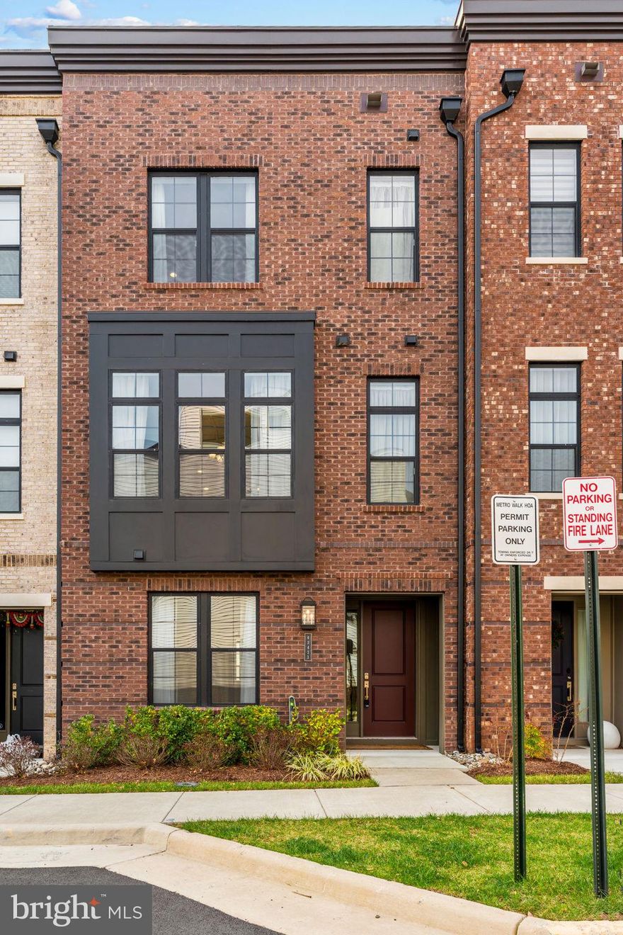 Step into this beautifully designed 3-bedroom, 3 full and 2 half bath townhome offering 2,631 square feet of modern living in the sought-after Metro Walk community of Ashburn, where thoughtful layout, natural light, and contemporary finishes come together for everyday comfort and effortless entertaining.

On the main level, the home opens into a bright and welcoming open-concept living space that flows seamlessly from the spacious living room into the dining area and gourmet kitchen. The kitchen serves as the heart of the home, featuring generous cabinetry, sleek countertops, and ample prep space, perfect for both casual mornings and hosting guests. Large windows fill the space with natural light, while the layout creates an easy connection between gathering spaces, making it ideal for modern living and entertaining alike. A convenient powder room completes this level.
 
The upstair levels, the bedroom level feels like a peaceful retreat highlighted by a spacious primary suite with a private en-suite bath and 2 generous walk in closets. The other well-proportioned bedroom provides flexibility for guests, family members, or a dedicated home office, supported by another full bathroom and convenient access to the laundry area. The design balances privacy and practicality while maintaining a bright, airy feel throughout.

The top level is ready to host your next rooftop gathering. From a large balcony, enjoy the views overlooking Ashburn. Walk through the large sliding doors into a recreation area that can also function as a meditation area or setup your home gym.

The lower level expands the home’s versatility with additional finished living space and another full bath, ideal for a guest suite, media lounge, workout area, or work-from-home setup. Whether used for entertaining or quiet relaxation, this level adds valuable flexibility to fit your lifestyle.

Located in the vibrant Metro Walk neighborhood, the home places you just minutes from everyday essentials and major commuter routes. Enjoy quick access to the Ashburn Metro Station on the Silver Line for easy travel into Tysons, Arlington, and Washington, DC, as well as convenient proximity to Washington Dulles International Airport. Nearby shopping, dining, and entertainment options at Broadlands Marketplace, One Loudoun, and surrounding Ashburn centers make daily errands and weekend outings effortless while keeping you connected to everything Loudoun County has to offer.

This is the kind of home that blends space, style, and location, ready to support the way you live today. Schedule your tour today!