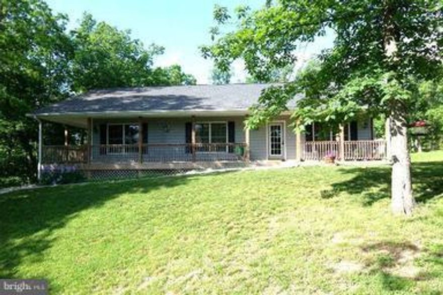 Peace and tranquility surround this ranch home on 3 acres. Upgrades throughout; wood floors, spacious/open kitchen with center island and 2 pantries. Upgraded appliances; washer and dryer included. Huge laundry room with storage cabinets. Large front porch; covered back porch. 3-4 bedrooms. 3 bedroom perc; 4th room can be office or bedroom. Within 10 minutes of shopping.