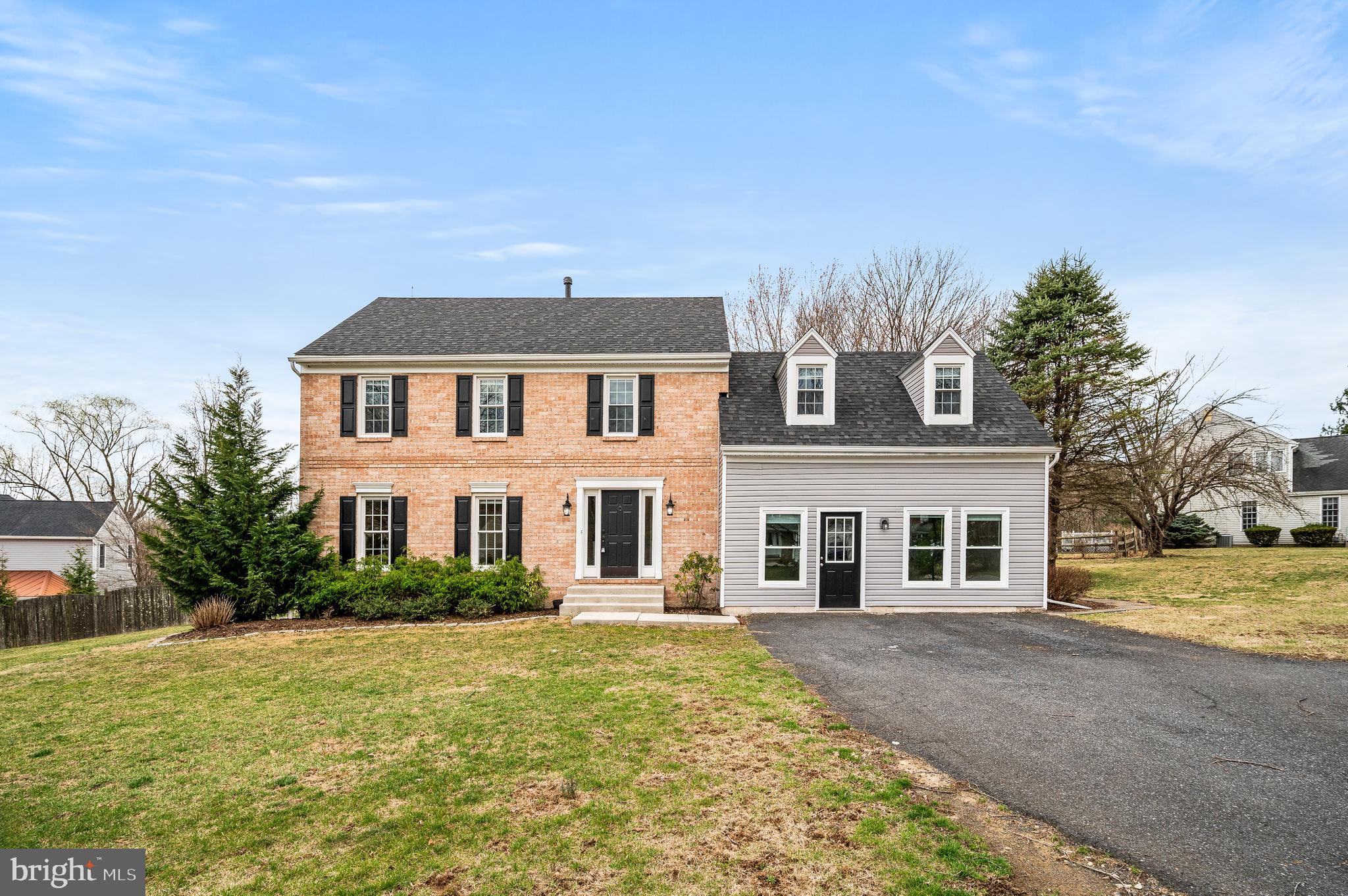Absolutely beautiful updated 2 story colonial home in a mature landscaped neighborhood! This beautiful home will attract you immediately with deep hardwood flooring throughout the 1st floor! Enter through the front door and you will find a staircase leading to the 2nd level, 1/2 bath, coat closet and straight ahead the gorgeous open bright kitchen featuring an island with pendant lights, quartz countertops, farm sink, exposed brick wall, recessed lighting, pantry, built in microwave, double door fridge with water/ice, bright white cabinets, door to the laundry area and garage as well as to the large side relaxing deck! Behind this great kitchen you will find a large amazing family room complete with vaulted ceilings, wood burning brick fireplace, recessed lighting and French Doors to the side patio! Additionally you will find a formal dining room and large formal living room. The 2nd level of this home features 4 very good sized bedrooms including the main bedroom - full bath with beautiful tiled shower, tile floor and double sinks as well as two double door closets and linen closet! The hall bath is completely remodeled. This home is beautiful with updated roof, HVAC, Plumbing, Electrical, Flooring, 2 exterior sitting areas and beautiful yard space. Additionally you will find an attached converted 2 car garage in to multifunctional space( not heated), full basement and plenty of parking in the driveway area!