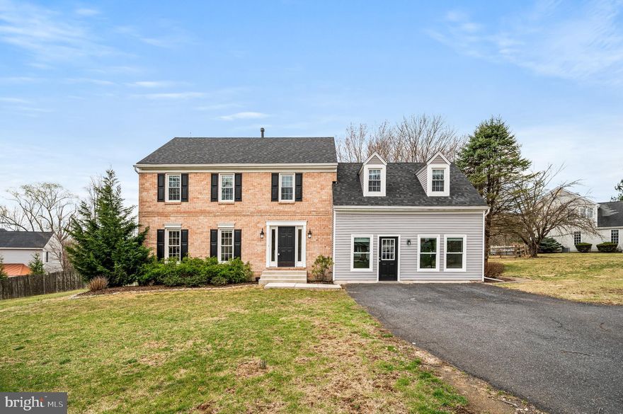 Absolutely beautiful updated 2 story colonial home in a mature landscaped neighborhood! This beautiful home will  attract  you immediately with deep hardwood flooring throughout the 1st floor! Enter through the front door and you will find a staircase leading to the 2nd level, 1/2 bath, coat closet and straight ahead the gorgeous open bright kitchen featuring an island with pendant lights, quartz countertops, farm sink, exposed brick wall, recessed lighting, pantry, built in microwave, double door fridge with water/ice, bright white cabinets, door to the laundry area and garage as well as to the large side relaxing deck! Behind this great kitchen you will find a large amazing family room complete with vaulted ceilings, wood burning brick fireplace, recessed lighting and French Doors to the side patio! Additionally you will find a formal dining room and large formal living room. The 2nd level of this home features 4 very good sized bedrooms including the main bedroom - full bath with beautiful tiled shower, tile floor and double sinks as well as two double door closets and linen closet! The hall bath is completely remodeled. This home is beautiful with updated roof, HVAC, Plumbing, Electrical, Flooring, 2 exterior sitting areas and beautiful yard space. Additionally you will find an attached converted 2 car garage in to multifunctional space( not heated), full basement and plenty of parking in the driveway area!