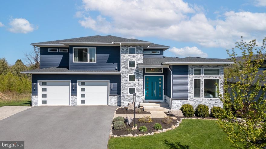 A Contemporary Masterpiece in the heart of Rockey Ridge. Nestled on an elevated lot with breathtaking views of Tussey Mountain, this 2019-built home by Olga Levi seamlessly blends modern elegance with exceptional comfort. Every detail has been thoughtfully crafted to create a truly refined living experience. Step inside to discover an open-concept design highlighted by natural maple hardwood floors, soaring ceilings, and expansive windows that flood the home with natural light. The heart of the home is the stunning, chef-inspired kitchen featuring a striking waterfall-edge 4'x7' island, modular cabinetry, quartz countertops, and premium Bosch appliances. Adjacent to the kitchen, the dining area opens into the spacious living room with soaring 20-foot ceilings. An impressive stone fireplace and built-in sound system create the perfect setting for both relaxing nights and lively gatherings. Step outside onto the spacious composite deck to savor seamless indoor-outdoor living and panoramic views. The main floor also features a sun-drenched bedroom with an en-suite bath, a half bath and mudroom. Upstairs, the luxurious primary suite welcomes you with breathtaking sunrise views, a walk-in closet and a spa-like bathroom complete with a soaking tub and custom-tiled shower. Two additional bedrooms, a full bathroom and laundry room complete the upper level. The fully finished walk-out lower level is an entertainer’s dream, boasting a home theater which is outfitted with an HD projector and pre-wired speakers for the ultimate cinematic experience. The lower level is complete with an additional bedroom, office/den, and full bath, and opens to a private patio with a 7-seater hot tub. Additional highlights include a high-efficiency geothermal heat pump, a radon mitigation system, smart-home technology, a Tesla solar Powerwall, and a spacious three-car garage. Prime location near historic Boalsburg and downtown State College.