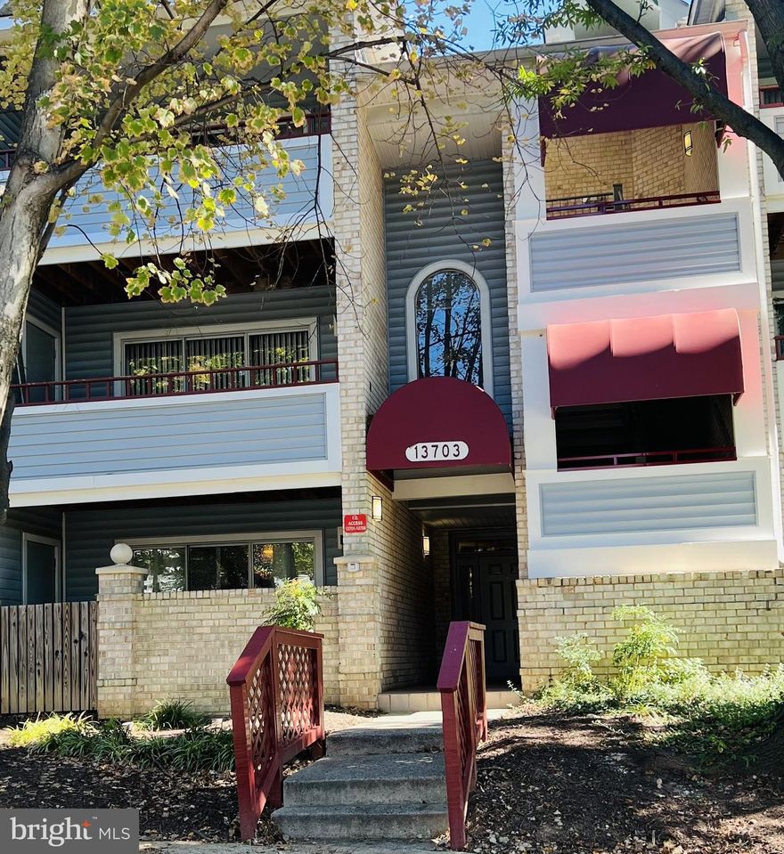 AS IS!  This bright and spacious 2 bedroom/2bath is settled on the first floor.  This open floor plan features a kitchen with breakfast bar, separate dining area, a large living room with wood burning fireplace, and a walkout private patio. Lots of closet space, full size stacked front load washer/dryer, and hardwood flooring.  Close to 95 the ICC, as well as dining & shopping.