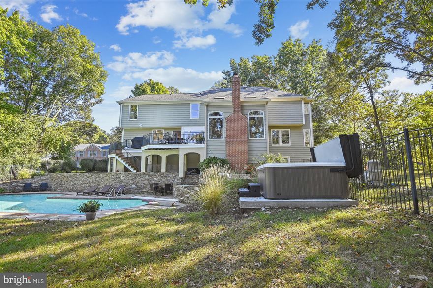 Welcome to this 5,850-finished square-foot Waterfront home in Ulmstead Cove. It is impressive all on its own but has fantastic views to boot.  The large deck, stone patios, and sprawling lawns make it a home you can admire as you enjoy the beautiful setting.  At nighttime, the hot tub beckons under the open sky and water view. The backyard is a welcoming outdoor retreat with a Mediterranean feel and a paved stone patio. It's the ideal outdoor entertaining space with a pool and fire pit. The professionally landscaped yard features an irrigation system to keep your home looking great on this .74 acres,  leaving you free to enjoy your lifestyle. The trees surrounding the property provide privacy without sacrificing the beautiful water views. Step down your stairway to all your water sports activities on the 145 plus ft water frontage. The pier has a new 13,500 lb, boat lift, and a fully wired pier area on a dedicated circuit. Step inside to an expansive, open floor plan on the main level with cathedral ceilings and views that will wow you—hardwood flooring throughout.
While heading into the fully renovated kitchen, this hallmark of gourmet kitchens will be the envy of any chef. It has plenty of storage, including a center island with a built-in microwave, ample counter space, and bar stool seating options. The kitchen also features Viking appliances, a gas six-burner stove, and Quartz countertops. Walk into the great room with a ground-to-ceiling stone gas fireplace and large windows for stunning views of the backyard oasis. Step outside through the solid French doors that lead to the upper deck and your sanctuary.  Inside, on the main level, you will find a fully remodeled ½ bath with marble flooring & shiplap walls. Formal dining room for all your family gatherings. Formal living room with wood-burning fireplace. Work will be a pleasure in an office with a water view. 
Head to the upper level, four bedrooms, and three full baths. The Primary Suite has a large walk-in closet and a wood fireplace for cozy nights. Dual vanity with stone backsplash, stone shower, and so much more. A jack-and-jill bathroom connects two bedrooms. The lower level is an entertainer's dream! The recent basement renovation added a media room and a fifth bedroom. Vinyl core flooring throughout. With the fully remodeled fifth bedroom, work out in your home gym with a water view through the solid French doors. Friends and family can gather in the large game room and a fully remodeled media room. The Bonus room/ bedroom and half bathroom are perfect for your guests.  Ulmstead community pool requires a special membership fee, not part of Ulmstead Cove.   Call me for a private showing, and this one won't last long!