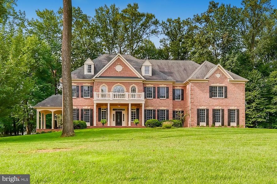 A magnificent all-brick custom home on 1.4 acres in beautiful neighborhood on quiet no-through street - bordered by towering trees and green space. Open floor plan, contemporary elements, and fine finishes include wide-plank Brazilian cherry hardwood floors throughout, custom cabinetry and unique architectural details. Stunning two-story foyer with curved double staircases opens to formal living and dining rooms, and spectacular family room with soaring ceiling, built-ins flanking gas fireplace and a gracious rear staircase. Gourmet white kitchen features a 6-burner Wolf gas range with grill and double ovens, 48" refrigerator/freezer, and expansive island adjacent to spacious light-filled morning room leading to home office/bonus room and full bath, a laundry and mud room. Beautiful casual living spaces feature a sunroom, a study or main level guestroom with wet bar leading to covered brick terrace offering retreat, alfresco dining, and outdoor play. Owners bedroom suite with lux bath, two large walk-in closets and sitting room with coffee bar opens to recently enclosed covered balcony now serving as large light-filled fitness room and second home office. The wide-open second level landing offers flexible living space for homework or second entertainment center adjacent to three additional bedrooms with en suite baths and a second laundry.  Conveniently located on the popular Falls Road Corridor just minutes north of Greenspring Station and bordering the renowned scenic Maryland Hunt Country byway. Travel 5 minutes past farm stands with locally grown produce, John Brown Store, 1100-acre Oregon Ridge Nature Center & Park to the Hunt Valley Center and Wegmans - or catch I-83 for a quick commute to the Best of Baltimore.
