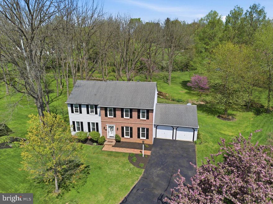 Backing directly to Brubaker Run, this exceptional brick Colonial offers rare privacy with nothing behind you but trees and natural beauty. Set on an expansive lot, the setting alone sets this home apart. Inside, you’ll find a beautifully updated kitchen, a formal dining room, and a versatile loft space that adds flexibility to the layout. Fresh paint throughout, along with newly refreshed shutters, gives the home a crisp, move-in ready feel. A classic brick fireplace anchors the living space, while upper and lower decks create seamless indoor-outdoor living. The walkout finished basement adds even more usable space for entertaining, relaxing, or everyday living. Homes with this kind of setting and care are hard to come by.