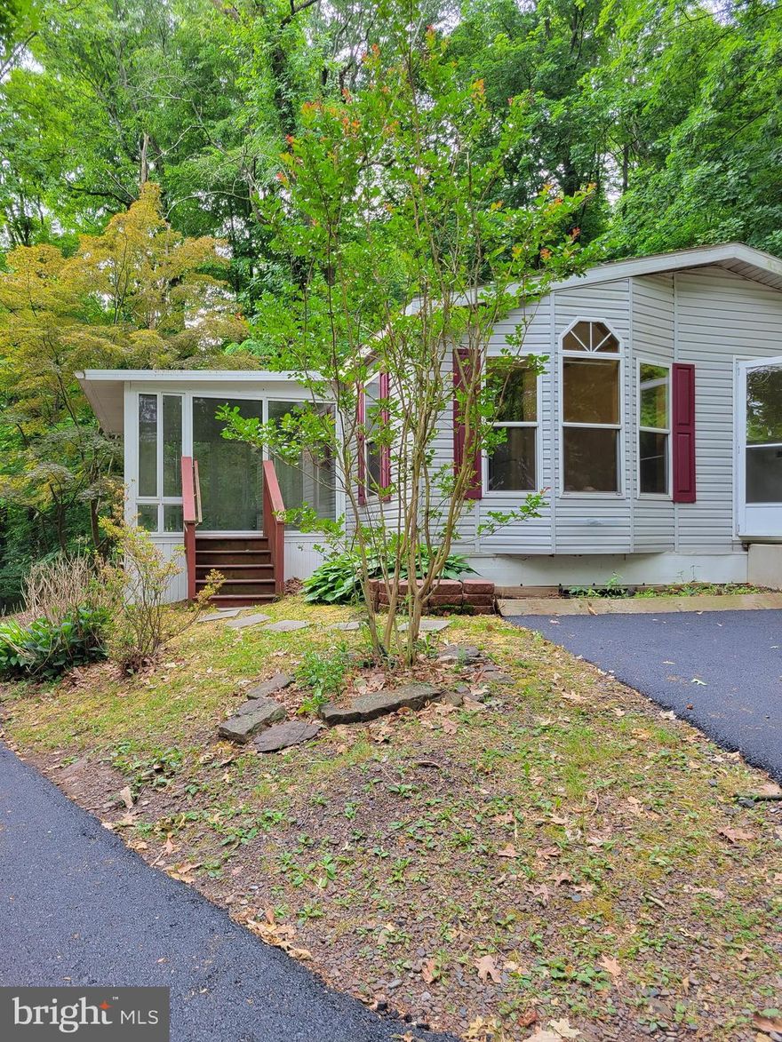 NO PETS!  This is not a pet friendly home.  Up on a hill in the amazing school district of Spring-Ford sits this 2 bed/2 bath modular home with basement.  This home sits up above the walking trail and the Perkiomen Creek in the woods but close to the Towne Center shopping center.  Enter up the newly paved driveway to find a great home with plenty of parking.  You can enter through the mud room  into the home.  From the mudroom, you immediately come into the Dining Room or call it an eat in country kitchen.  It is large and welcomes natural light.  The kitchen has plenty of cabinets for storage.  Walk through to the other side of the kitchen and you will find yourself in the Living Room which is large and also the entrance to the enclosed sun porch.   From the Living Room you can access the hall way which is where you will find the Primary bedroom with it's own bathroom as well as the Hallway bath with tub and the 2nd bedroom.  There is a full, unfinished basement for storage.  The landlord is looking for all adults over 18 to have a credit score of 600 or more, with no criminal background.  No exceptions to the no pet rule.