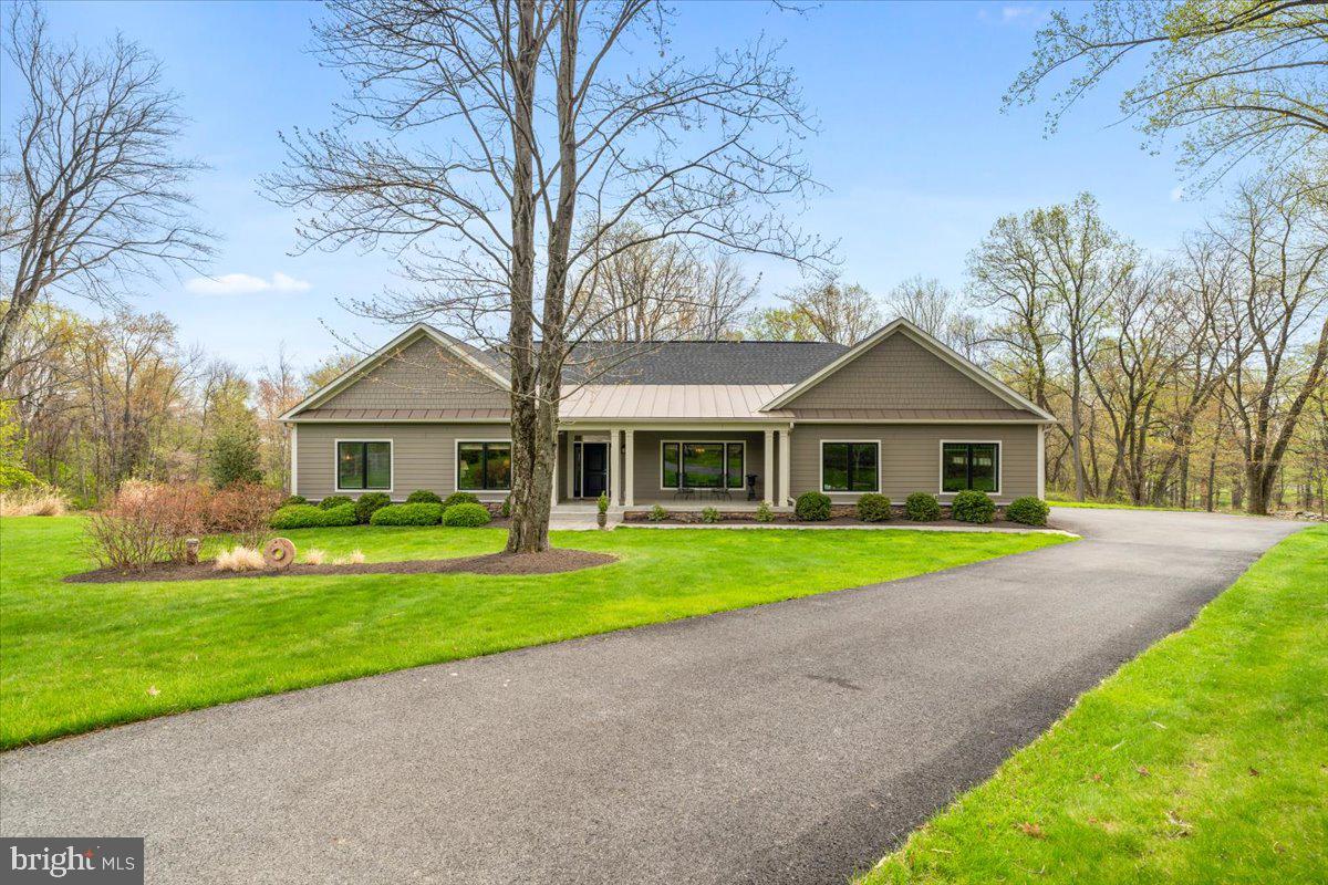 If you find yourself driving outside of the Frederick City limits, getting lost for a weekend drive, you may stumble upon this amazing custom designed and custom built Rancher sited on over three acres. This was the first home built in the Arrowood subdivision for good reason--it is one of the finest lots you will find in all of Frederick. This meticulously maintained home offers the perfect blend of privacy, one level living, and serenity. The home was thoughtfully and loving designed, incorporating luxurious green design concepts such as geothermal. As you enter, the main level boasts hardwood flooring throughout and is designed with entertaining in mind. The bright open eat-in kitchen offers high end appliances including a wall oven, six burner stove, plenty of cabinet space and a large kitchen island. The kitchen leads seamlessly to an eat-in area. And the eat-in area leads to a gorgeous screened in porch and outdoor living. The family room is flanked by a gas fireplace and leads out to your flagstone deck overlooking an incredible landscape. A luxurious primary suite with one of the best views in the home features windows on two sides and a large en-suite bath. The primary bathroom has a massive walk-in shower, double vanity and beautiful tile. There is a dressing area with multiple closets and closet organizers. The primary suite is strategically positioned in one wing of the home. The other wing has two additional bedrooms and a recently renovated hall bath. The hall bath has gorgeous finishes and exudes luxury. Additional features of the main level are a formal dining room looking out to the front porch and yard. You may also enjoy the sitting room to unwind or read a book. There is also a main level laundry, mudroom and powder room. The partially finished basement expands the full length of the home and can be used as additional living space or transformed into a rec-room and three additional bedrooms. Uniquely, the home has a six bedroom perc and the layout for two additional bedrooms in the basement with egress windows, rough in plumbing is very intuitive. The basement walks up to the side yard and has great ceiling height. Every detail of this home reflects the care and pride of its current owner, with thoughtful design choices and upscale finishes throughout. Move-in ready and truly exceptional, this is a rare opportunity to own a home of this caliber—don’t miss your chance to make it yours. The cost of this lot and construction to build new would far exceed the value in this price. Uniquely close to downtown Frederick, you will enjoy the location without city taxes. Welcome home!