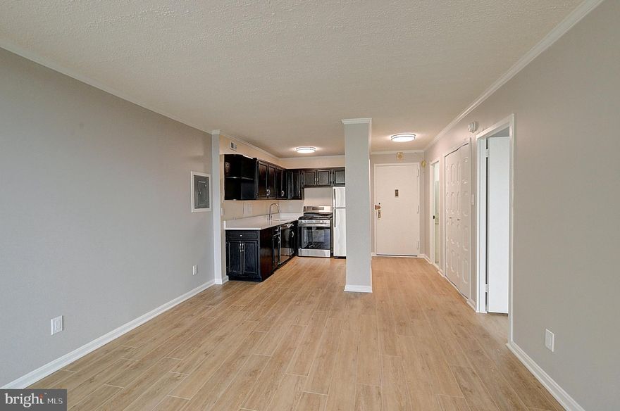 This bright, well-maintained 1-bedroom residence offers 630 square feet of open living space with crown molding throughout the main area and bedroom and new laminate flooring that runs seamlessly from room to room.
<br><br>
Ceiling asbestos abatement has been fully completed.
<br><br>
The spacious living and dining area opens to a private balcony facing the horseshoe courtyard, with a partial view of the pool from certain vantage points and a comfortable sense of privacy. Large sliding glass doors fill the space with natural light and extend the living area outdoors.
<br><br>
The kitchen features dark cabinetry, a stone countertop, and a full GE appliance suite, including a new oven, dishwasher, and refrigerator. The layout provides efficient prep space and clean lines for everyday use.
The bathroom has been updated with refreshed tile, vanity cabinetry, fixtures, and flooring while retaining the existing counter. A new electrical panel has also been installed.
<br><br>
The bedroom offers generous proportions, natural light, and ample closet storage.
<br><br>
The monthly co-op fee covers all utilities, including electricity, gas, water, sewer, heating, air conditioning, cable TV, real estate taxes, building insurance, parking, and access to building amenities.
<br><br>
The Promenade offers indoor and outdoor pools, tennis and pickleball courts, a fitness center with sauna, 24-hour security, concierge service, and an on-site arcade with shops and essential services.