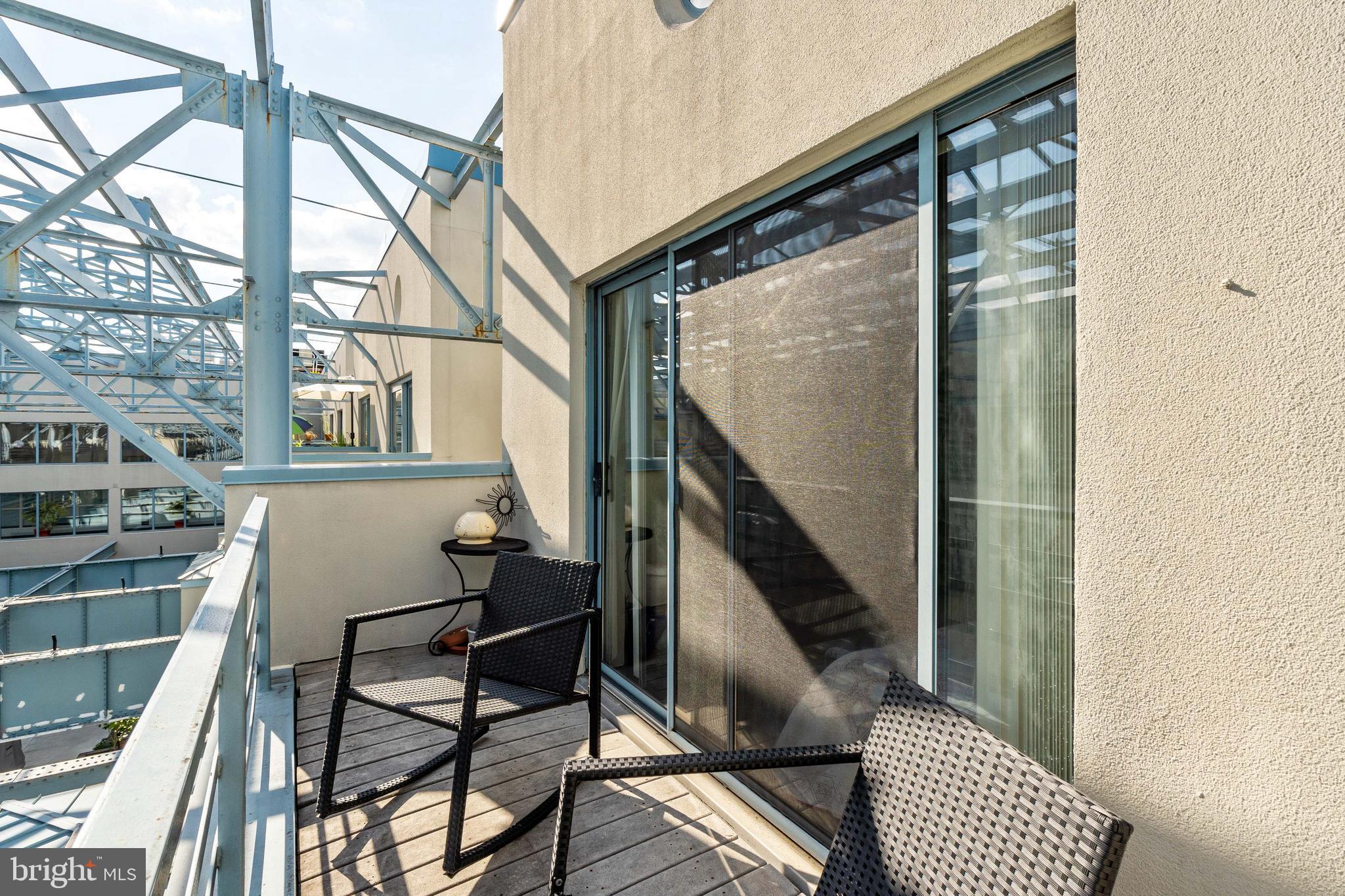 UPDATED PHOTOS COMING SOON! Sun-soaked two bedroom, two bathroom with river views and a private balcony at Pier 3 Condominiums. This spacious two bedroom home showcases gorgeous views of the marina and Ben Franklin Bridge, oversized windows throughout, and an eat-in kitchen. Enter through a foyer into the light-filled great room providing a cozy fireplace, large windows overlooking the marina, and ample space for separate living and dining areas. Both bedrooms are generously sized and boast excellent closet space. Unique to this unit, the primary suite features a large private terrace serving as the perfect spot to enjoy a morning cup of coffee throughout the warmer months. The primary bedroom has an ensuite bathroom and the second bedroom enjoys use of a nearby full hall bathroom with stacked washer/dryer. Additional highlights include a lower level foyer with large coat closet, high ceilings, and exposed metal beams throughout. There are brand new vinyl floors throughout and the kitchen and bathrooms are currently being renovated. Residents of Pier 3 enjoy a twenty-four hour doorman, heated indoor pool, fitness center, and one first come, first served parking space.