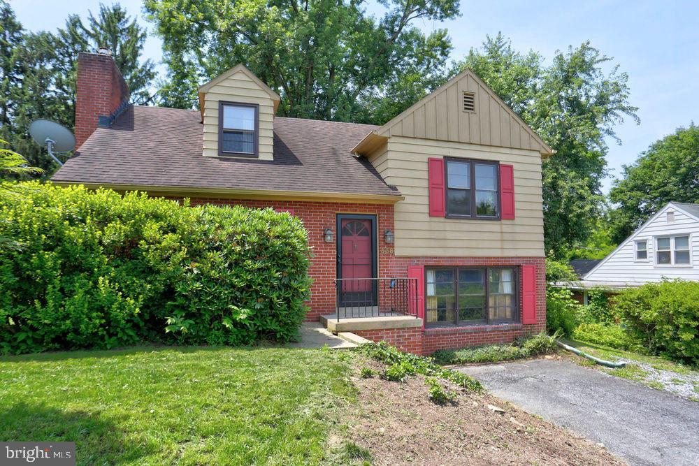 Nestled on a mature lot, this quaint 4-level cottage-style home has a cheerful vibe at every turn. Each room offers it's own whimsical character with hardwood floors, vibrant color, wainscoting and original piney oak. The kitchen features tile counters and backsplash, built-in buffet in the dining area, and lots of working space. A screened porch overlooks a private back yard, that is filled with beautiful trees, shrubs and flowers. If you are looking for a delightfully unique environment to call home, this house is for you!