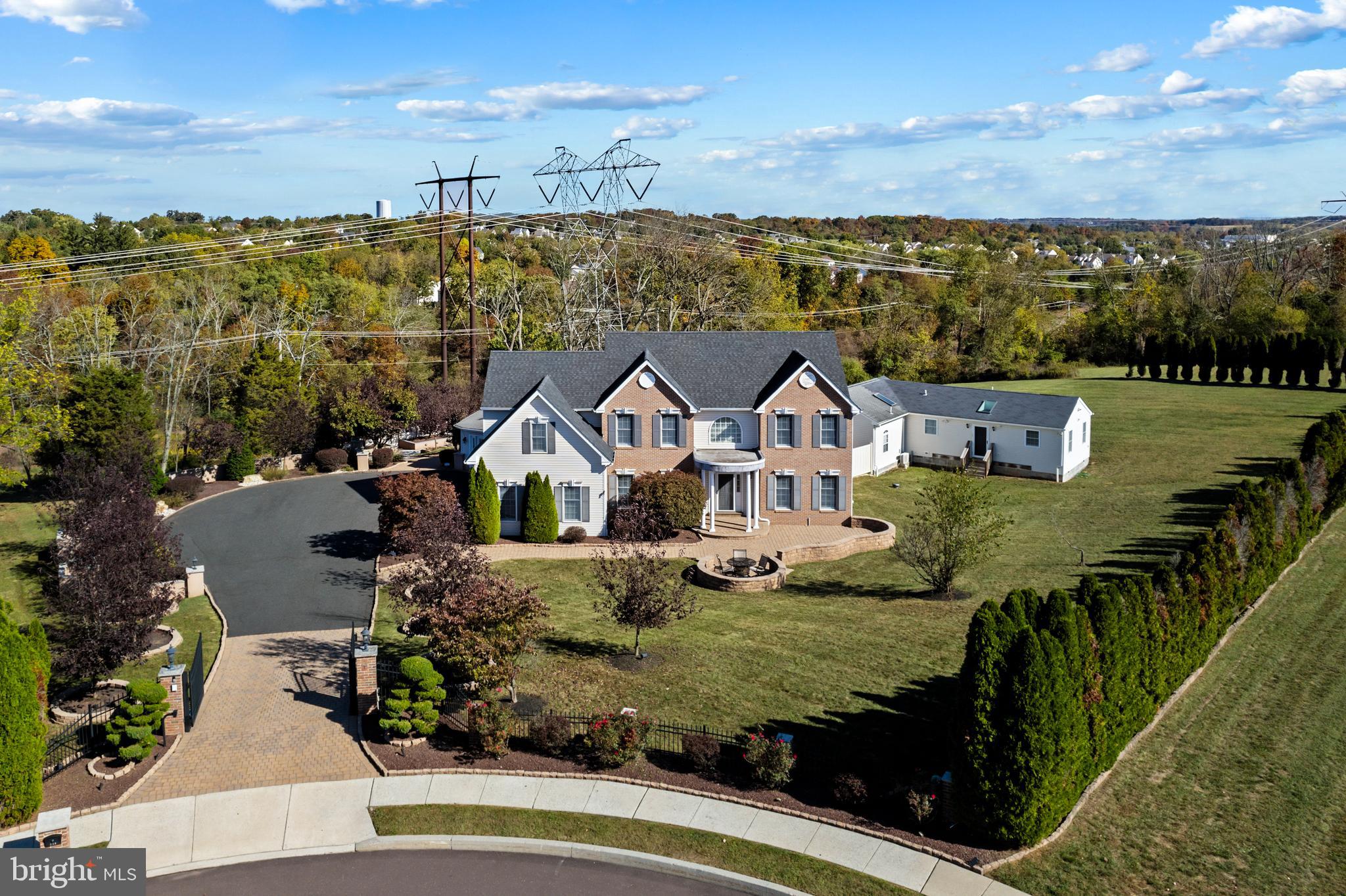 The Mainline and The Hamptons located right here in Collegeville, Pennsylvania, 140 Meadowland Drive.
This luxurious estate at 140 Meadowland Drive in Collegeville, PA, seamlessly blends modern comfort and high-end design. Boasting 5 bedrooms and 6 bathrooms, this 7,150-square-foot home is situated on 1.3 meticulously landscaped acres at the end of a quiet cul-de-sac, providing a sense of privacy and security. An automatic electric gate leads you down an expansive paver and macadam driveway, guiding you to the carpeted 2-car garage—your secure and welcoming entry point.
The home underwent a complete renovation in 2022, resulting in a blend of contemporary elegance and timeless style. A grand pavers deck extends from the main living area, offering a perfect view of the backyard’s stunning features. Central to the outdoor space is a pristine in-ground saltwater pool with impressive waterfalls, lighting, and a sound system, designed for both recreation and relaxation. As a sports pool, it’s shallow at both ends, making it ideal for water games, new swimmers, or simply lounging. The expansive concrete decking surrounding the pool provides plenty of space for gatherings, day or night. A pool house enhances the outdoor living experience, featuring a full bathroom, kitchenette, and plenty of room for changing or entertaining guests.
Sports enthusiasts will appreciate the private tennis and full-court basketball courts, perfect for staying active. Indoors, the main level features a state-of-the-art kitchen with a 14x3-foot quartz island, dual modern refrigerators, and sliding pantry space—ideal for culinary creativity. The adjoining family room has access to back stairs leading to the upper floors, while the Great Room, known as the West Wing, impresses with its versatility. This space serves as a meeting room, entertainment space, and more, leaving guests in awe.
The home also prioritizes relaxation, featuring a dedicated home gym and an oversized hot tub that comfortably seats eight or more. The finished basement provides additional living space, including a home theater, a full bathroom, a second kitchen, a soundproof recording studio, office space, and a billiards area. With soundproofing throughout, the basement is perfect for hosting events or simply enjoying time with family and friends.
For guests or extended family, the property includes a fully functional in-law suite attached to the main house. This space offers a separate entrance, a full kitchen area, and a private bathroom, making it ideal for visitors or multi-generational living.
Nicknamed the "elegant little giant," the home strikes a balance between spaciousness and intimacy, ensuring each room has a purpose. It's located within the highly regarded Spring-Ford School District, offering easy access to local amenities, parks, grocery stores, major highways, and premier shopping destinations like the Philadelphia Premium Outlets and the King of Prussia Mall. Nearby conveniences include Target, Giant, restaurants, and more.
With its high-end finishes, extensive amenities, and thoughtful design, this estate offers an unparalleled living experience. Don’t miss the opportunity to make 140 Meadowland Drive your new home—schedule a tour today to experience the charm, elegance, and comfort this property has to offer.