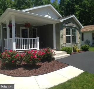 This is it! You will not find a better deal in Cecil Woods! Located on a quiet cul-de-sac and backing to forest and overlooking a community pond, this beautiful 3BR, 2BA home features many upgrades and is priced well below new construction in this community. Enjoy the benefits of living in the area's premier active adult 55+ community of Cecil Woods including the large community clubhouse!
