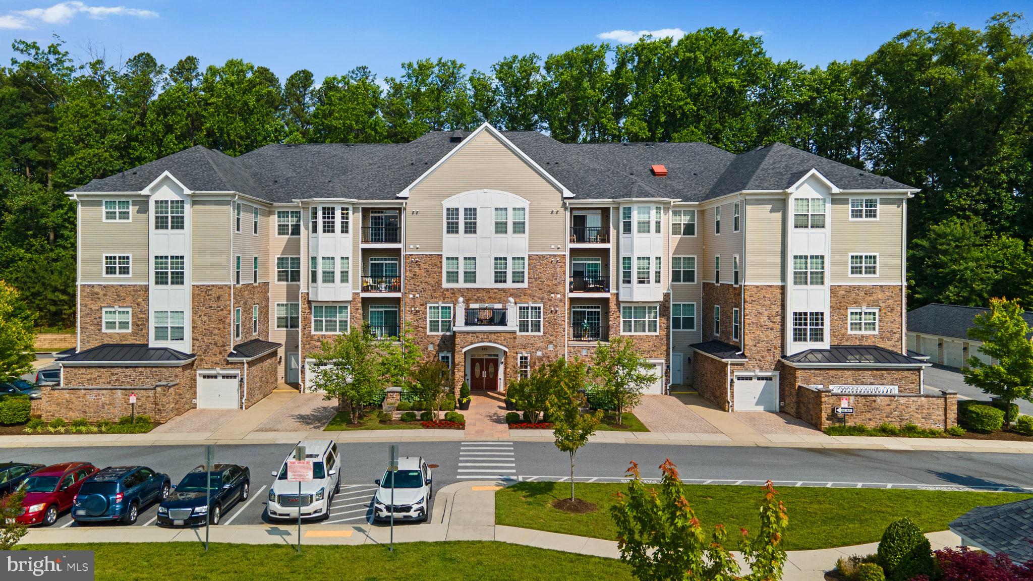 Enjoy low-maintenance, resort-style living in this well-maintained one-level 2 bedroom, 2 bath, elevator access penthouse condo located on the top floor with serene views of Quarry Lake and no neighbors above, located in the sought-after 55+ community of the Gatherings at Quarry Place. This condo is freshly painted and move-in ready. Inside, a bright and airy open-concept layout welcomes you, beginning in the entryway complete with a convenient laundry room. A well-equipped kitchen featuring stainless steel appliances, a gas range, 42 inch maple cabinets, granite countertops, and a peninsula breakfast bar overlooks the spacious living area, which opens to a private balcony showcasing peaceful views of the lake, trees, and community gazebo. The home offers two generously sized bedrooms, each with plush carpeting and access to full bathrooms. The luxurious primary suite is a true retreat, highlighted by a sun-filled sitting area with bay windows, dual closets—including a walk-in—and a spa-inspired ensuite bath with double vanities and a large walk-in shower with a built-in bench.
Residents enjoy exceptional community amenities, including a private garage, large clubhouse with a fitness center, outdoor pool and hot tub, social areas with grilling stations, sunbathing areas, community gardens, and a scenic 1-mile trail around the lake. Ideally located just minutes from Foundry Row, the MARC train station, and I-795, this home offers the perfect blend of ease, activity, and everyday convenience.