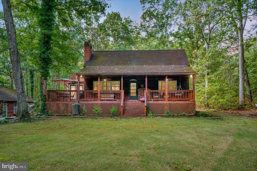 Welcome to your private hideaway! Nestled on nearly 9.5 acres of mostly wooded land, this cedar cabin is a hunter’s dream and a nature lover’s paradise. A long gravel driveway winds its way to the property, opening up to reveal a stunning 2.5-story cabin surrounded by thoughtfully designed outdoor living spaces.
The outdoor areas are as inviting as the home itself. A shaded front deck, a side deck perfect for BBQs, and a rear deck wired and ready for a hot tub create endless opportunities to enjoy the fresh air. Between the home and detached garage, a charming courtyard sets the scene for quiet gatherings, while the lighted basketball court offers a place for evening games. A children’s playground, a tranquil fish pond, and plenty of open yard space enhance the property’s appeal. Two storage sheds and a dog pen sit tucked away in the back for added convenience.

The detached oversized two-car garage provides more than just parking, with insulation, a dedicated power panel, and abundant storage. Attached to it, a climate-controlled man cave with its own private entrance and a pool table creates the perfect spot to unwind and entertain.

Inside the cabin, rustic charm blends seamlessly with modern comfort. The great room features soaring ceilings, exposed wooden beams, a wood stove, built-ins, and expansive windows that connect you to the outdoors. The kitchen is spacious and beautifully updated with granite countertops, stainless steel appliances, lighted cabinetry, and a stone backsplash, while the formal dining area fills with natural light and offers peaceful views of the property.

The main level includes two generously sized bedrooms and a full bathroom with a tile-surround tub and shower. Upstairs, an open loft makes an ideal office or reading nook and leads to the primary bedroom, which is accompanied by another full bathroom. On the lower level, a versatile flex space provides the option for a fourth bedroom or office, complemented by a large rec room perfectly suited for game nights or gatherings. A secure safe, a laundry and utility room, and a mudroom with direct access to the backyard complete the interior.

Additional features include a generator that powers three-quarters of the home, scenic walking trails, plenty of space for ATV riding, and prime land for hunting. This property offers not just a home but an entire lifestyle, one that balances privacy, comfort, and adventure in a truly one-of-a-kind setting.