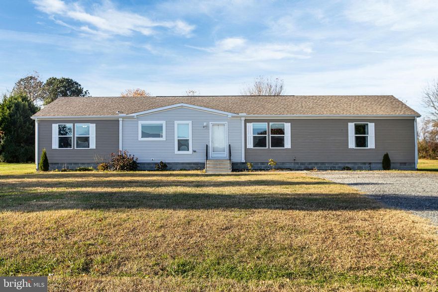 This four-bedroom, two-bath home captures the balance so many Delaware residents love—comfortable space, quiet living, and easy access to everything you need. Built in 2018 and set on a wide three-quarter acre lot, it offers room to spread out without giving up convenience.

The location is ideal for those who work in nearby towns or commute across state lines. Routes leading to Dover, Camden, and Harrington are just minutes away, and you’re within reach of major corridors connecting Delaware to Maryland, Pennsylvania, and New Jersey. It’s a setting that delivers the best of both worlds—small-town calm with regional connection.

Inside, the single-level layout makes daily living simple and relaxed. The home opens to a large living space with durable plank flooring and large windows that fill the rooms with natural light. The kitchen features generous counter space, cabinetry, and a center island—perfect for weeknight meals or casual entertaining. A separate laundry room adds everyday convenience, while the primary suite offers a private retreat complete with a soaking tub, separate shower, and walk-in closet.

Step outside to enjoy a large back deck overlooking open green space, a great spot for cookouts, a pool, stargazing, or letting the household pet out for some air. The expansive yard leaves plenty of room for future additions, gardening, or play.

Whether you commute out of state for work, value open land, or simply want a space to relax in a well-connected part of Kent County, this property makes it all possible.