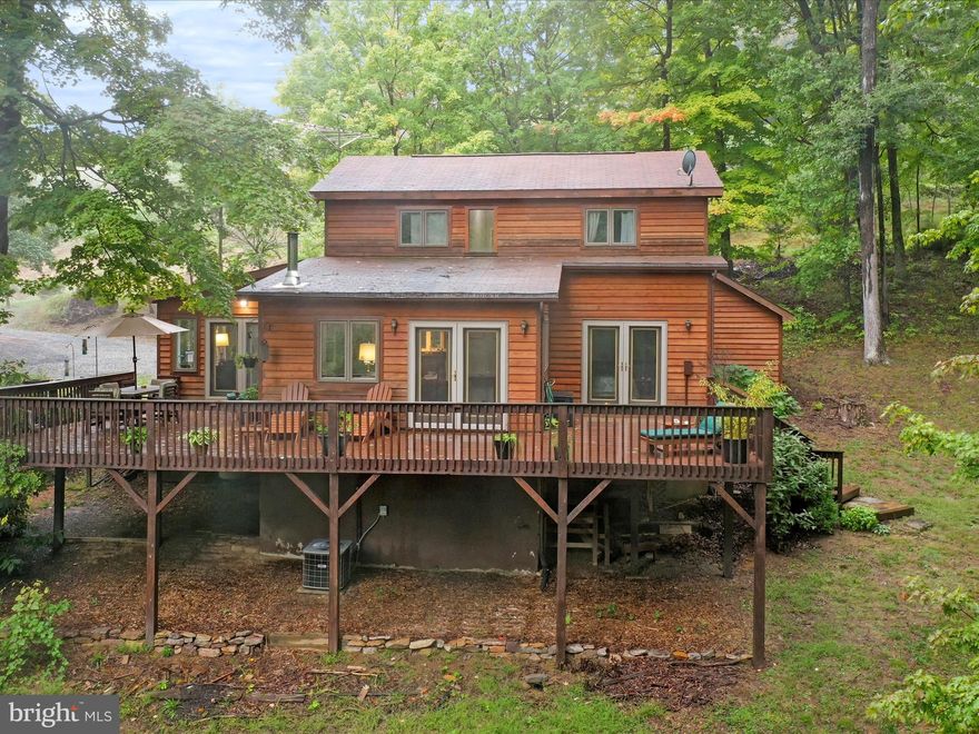 Lovely 2 story cedar sided home within 4 miles of Historic Berkeley Springs, WV.  The house features a wrap deck on 2 sides in a mostly wooded peaceful setting in Coolfont Moutainside subdivision.  There are 3 bedrooms and 3 bathrooms, a cozy sunroom, living room with a wood burning stove for cool evenings, the kitchen has all appliances, lots of built in book shelves.  The owners bedroom and bath are on the main level.
The potential for income from short term VRBO or Airbnb is a plus as the homeowners association allows this.
The property is within walking distance to the bar and restaurant at Coolfont and The Brewery on Cold Run Valley Rd.
Coolfont Mountainside has private tennis courts and an outdoor swimming pool for homeowners.
Visit the historic town of Berkeley Springs for numerous spas, Berkeley Springs State Park and shopping.
Only a few miles to Cacapon State  Park for hiking, golf on the Robert Trent Jones 18 hole course, enjoy the lake and picnic area/playground.
So many things to keep you busy, or just relax at the house.