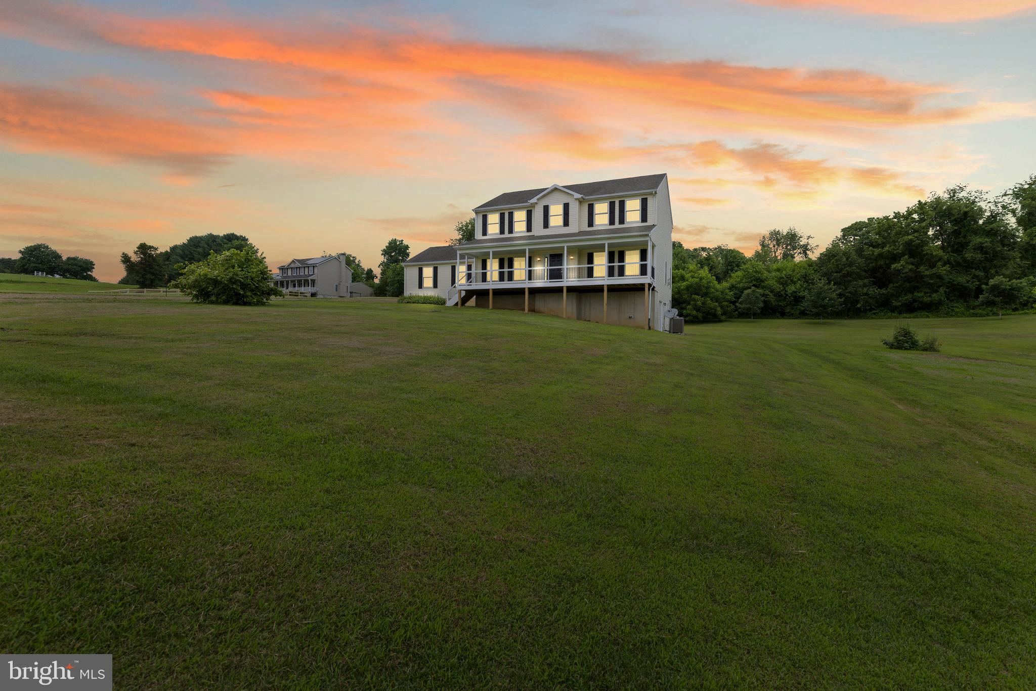 Set on over 2 acres in Conowingo, this spacious 3-level Colonial offers 5 bedrooms, 3.5 baths, and more than 3,600 square feet of finished living space. The main level features hardwood floors, 9' ceilings, and a beautifully remodeled kitchen with quartz countertops. The fully finished walkout lower level includes its own kitchen, living area, bedroom, and full bath—ideal for guests, in-laws, or multi-generational living. Outside, enjoy a new composite front porch and rear deck, an attached 2-car garage, and a detached 2-car garage with electric. Additional highlights include a whole-house Generac generator, two owned LP tanks, and a cozy propane fireplace with insert, HVAC system replaced and upgraded, well pump replaced, dishwasher replaced, and the water heater was replaced and upgraded to a larger model. Tucked away on a private road shared by just three homes, this property offers a rare blend of privacy, space, and versatility.