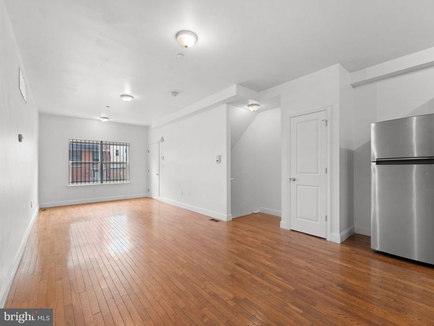 Built in 2012, 1910 N Gratz Street offers two spacious bi-level apartments totaling 7 bedrooms and 4 full bathrooms, making it ideal for student housing, owner-occupancy, or long-term rental income.Unlock the full potential of your investment with this modern, income-producing duplex located just three blocks from Temple University’s Main Campus. Unit A – Vacant & Ready for Lease or Owner-Occupancy
Unit A is a 4-bedroom, 2-bath tri-level apartment that is currently vacant and available for immediate lease, providing flexibility for an investor to set market rent or for an owner-occupant to move in. The open-concept layout features hardwood floors, tall ceilings, and oversized windows that fill the space with natural light. The modern kitchen flows seamlessly into the living area and includes contemporary cabinetry, ample counter space, and full appliances. The layout is thoughtfully designed for privacy, with bedrooms located across multiple levels: one bedroom on the main level, two upstairs, and an additional bedroom on the lower level. Two full bathrooms feature stone tile flooring and large vanities. The lower level also offers a bonus living area, perfect for a second lounge, home office, or fitness space, along with in-unit washer and dryer. Unit B – Stable Income in Place. Unit B is a 3-bedroom, 2-bath bi-level apartment currently leased to a Section 8 tenant at $1,700/month through May 2027, providing reliable cash flow. This unit features a bright living space, modern kitchen, in-unit laundry, and access to a private rear yard, a rare and desirable feature in this location. Both units offer separate utilities, generous square footage, and modern finishes that attract strong tenant demand. The property is ideally situated between W. Berks Street and W. Norris Street, just steps from Broad Street, the subway, public transportation, shopping, and campus amenities. Whether you’re a seasoned investor or a first-time multifamily buyer, this property combines location, flexibility, and long-term appreciation potential in one of Philadelphia’s most active rental markets..