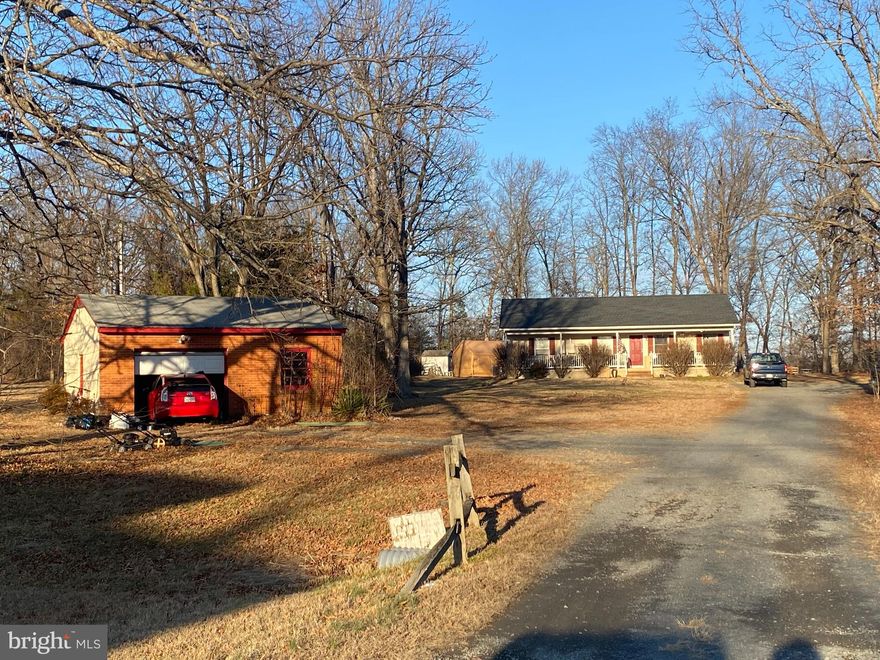 You will not want to miss this amazing opportunity on 2.2 acres right at Linton Hall and Sudley Manor Drive. Beautiful country style front porch. Main level living. This one level home features 3 bedrooms, 2 full baths, living room, dining room, and laundry room. Walkout from main level onto deck perfect for entertaining. Separate garage with water and electric. Separate trailer with electric, perfect for an office. Storage shed. Roof 2 years old. Newer water heater. Close to all the great dining and shopping Bristow has to offer. Minutes to Gainesville, I66, and commuter lot. NO HOA. Home needs some updates and is being sold AS IS. Come fall in love.