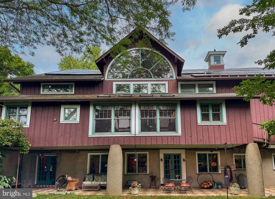 Welcome to 113 Cumberland Place, a breathtaking multi-year renovation of a banked dairy barn, nestled in the coveted neighborhood of Bryn Mawr, PA.  This extraordinary home boasts an impressive 6,000 square feet of living space, combining rustic charm with modern amenities. The multi-story converted hay loft area offers incredible flexibility for hobbies, car collecting, woodworking, trades work, and indoor recreation, supported by 4 propane heaters in a spacious two-story open area. A push/pull trolley under the ridge beam offers direct access to the cupolas and roof, adding to the home’s unique charm. Situated on .42 acres of serene, lush grounds, this residence features 4 well-appointed bedrooms and 3 full baths. A unique highlight is the Lafayette Loft, a two-story Airbnb suite with living space, full bathroom, and loft area with bed, generating an additional $23,000 per year. The hay loft has a separate entrance, adding to the home’s versatility. A main floor Saltillo tile entrance offers multi-purpose space that could be an additional Airbnb guest room, office or studio, previously housing an architectural firm.  The living/dining areas feature hand sanded old growth Pennsylvania pine floors and a three-story atrium that floods the space with light. The all-white kitchen is equipped with granite countertops and a wood block island. There is a four-burner Wolf gas cooktop, a Thermador oven, and Kitchen Aid dishwasher making it an efficient cooking area. On the second floor a sunroom with 4 skylights, Saltillo tile floor, and laundry room connect the two bedroom areas. The primary suite featuring a vaulted ceiling and a dressing room expansion offers abundant closet space. The generous bedrooms offer ample closets, while various nooks and crannies provide additional storage solutions for a clutter-free living experience. Located within the highly regarded Radnor Township School District, this property is ideal for families seeking a distinctive living experience. This home is steeped in history, with a covered front patio and beams and timbers that tell a story. Now, it’s ready for you to write the next chapter. Don’t miss our exclusive website for this home, featuring a 3D Matterport tour, Virtual Reality Walkthrough, detailed floor plan, professional photography, and aerial drone footage. Note: Some photos have been digitally enhanced. Additional features include spiral staircases, many of the floors are hand sanded barn wood, beamed ceilings, Dutch doors, two custom-built cupolas, and 88 solar panels providing significant electric savings. Conveniently located near downtown Bryn Mawr and Wayne, with access to shopping, upscale restaurants, and top healthcare systems. Easy access to King of Prussia Mall, Rt. 476, Rt. 76, PA Turnpike, and I-95 to Philadelphia International Airport. Hurry to make this your new Main Line heritage home!