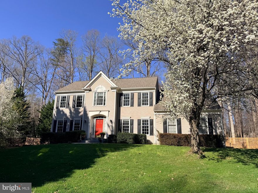 Welcome to the highly sought-after Meadowbrook Woods community!  Situated on just over a half-acre, this beautifully maintained home features a fully fenced rear yard, spacious deck, and a 2-car, side-load garage. The main level showcases stunning site-finished hardwood flooring, an upgraded kitchen with stainless steel appliances, granite countertops, and a bright, open layout.  Enjoy a dramatic family room with a cathedral ceiling, along with a formal dining room, a dedicated office, and a formal living room with a cozy gas fireplace.    Upstairs you will find four generously sized bedrooms and two full bathrooms, including a luxurious primary suite with a spa-like bathroom you truly must see to appreciate!  The finished basement offers incredible versatility, complete with a full bathroom, a large recreation area, and an impressive bar space featuring granite countertops, sink, wine cooler, extra refrigerator, and seating area—perfect for entertaining.  Plus, the convenience of a storage room, a workshop/mudroom that exits to the backyard and an additional office/open area. This home combines space, style, and functionality in an unbeatable location—don’t miss it!