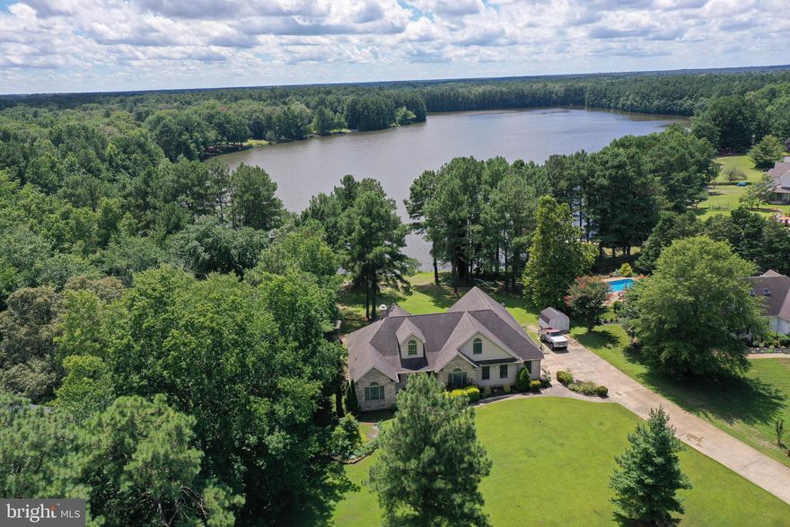 Welcome home to 8112 Pintail Drive! This masterfully crafted contemporary home situated in the private neighborhood of Lake Pines is waiting for its new owners to come and introduce themselves! 
Nestled on a small lake, this home boasts over 3,700 square feet of living space, with wide views of the water from the backyard and large rear deck, equipped with a 3 seasons room, perfect for entertaining or enjoying quiet relaxing waterfront views. Welcomed by a large foyer, you're greeted by a great room boasting a vaulted ceiling and brick fireplace, the great room opens into the kitchen and breakfast nook area, providing that open-concept feel. The kitchen offers ample counter and cabinet space, and off the kitchen you'll find a formal dining room with hardwood floors.
On one side of the home you'll find 2 large bedrooms and a common area bathroom equipped with a double vanity sink. Opposite side of the home, you'll find the primary bedroom, complete with walk in closet, and en-suite bathroom, featuring a walk-in shower, double sinks, and a desk-style vanity with separate mirror. The master bedroom also features double doors, offering a clear view of the lake and access to the rear deck as well.  Upstairs you'll find a large loft area, and additional bonus room that could be used for home office, and a half bathroom as well. 
Featuring a spacious 2 car garage with workbench and additional storage space. This home is equipped with a newer microboiler system, providing efficient radiant heat in the home.
Located in the country setting of Parsonsburg, enjoy the privacy of quiet rural living, while benefiting from the proximity of the city of Salisbury less than 10 miles away: Shopping, schools, entertainment, restaurants, Salisbury University, local minor league baseball stadium, and the local area hospital. Less than an hour's drive from the Maryland and Delaware beaches, love where you live, and play where you live! The current mortgage is a VA mortgage with a lower rate than today's standard, and could be assumed by qualifying buyers. 
Call today for your own private showing!