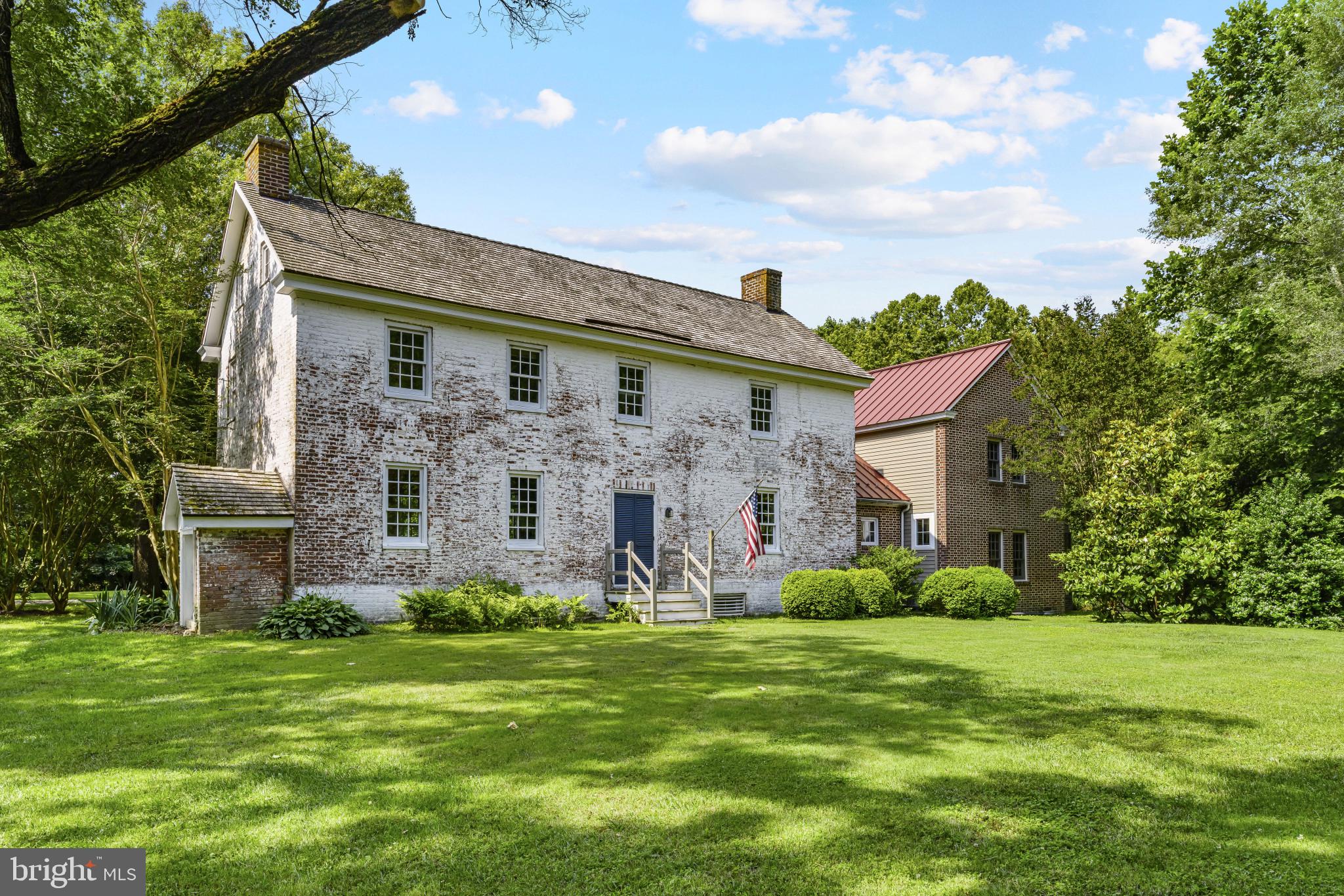 Historic Charm at "Lexon" – A Rare 18th-Century Gem
Welcome home to the tastefully updated historic residence at 411 Corsica Neck Rd. Originally built in the third quarter of the 18th century, Lexon is a remarkable two-story brick home that blends early American architecture with 19th-century updates. Featuring classic Federal and Greek Revival interior detailing, this home offers a rare opportunity to own a piece of Eastern Shore history on over 10 acres of land - just outside of town.
Tastefully remodeled to retain the historic character alongside modern conveniences, this home offers three spacious bedrooms including a primary suite with curly maple flooring overlooking the gardens with bonus office or library space. The kitchen has been beautifully updated and offers a pantry and coat closet off one of the entryways to the home. Off the kitchen is one of the main living spaces, connected to the screened in porch that overlooks the fenced pool and luscious gardens. The formal dining room offers the perfect place for social gatherings or quiet evenings by the hearth. A formal living room on the other end of the house is great for entertaining. The full basement and attic space plus detached 30x60ft barn / garage with partial second floor offer plenty of storage.
Set along Corsica Road, the property showcases traditional elements including a pitched gable roof, Flemish bond brickwork, original 9/6 and 6/6 sash windows, and flush gable-end chimneys. The home’s layout reflects evolving design sensibilities over time — originally oriented southward, the primary facade was shifted to face Corsica Road in the early 1800s.
Inside, you'll find carefully preserved mantels, moldings, and a striking staircase, as well as original partitioning and paneled walls that echo the craftsmanship of the home’s earliest days.
Lexon is a rare blend of preserved architecture and historical context — ideal for those who appreciate timeless detail and heritage seamlessly blended with modern conveniences.