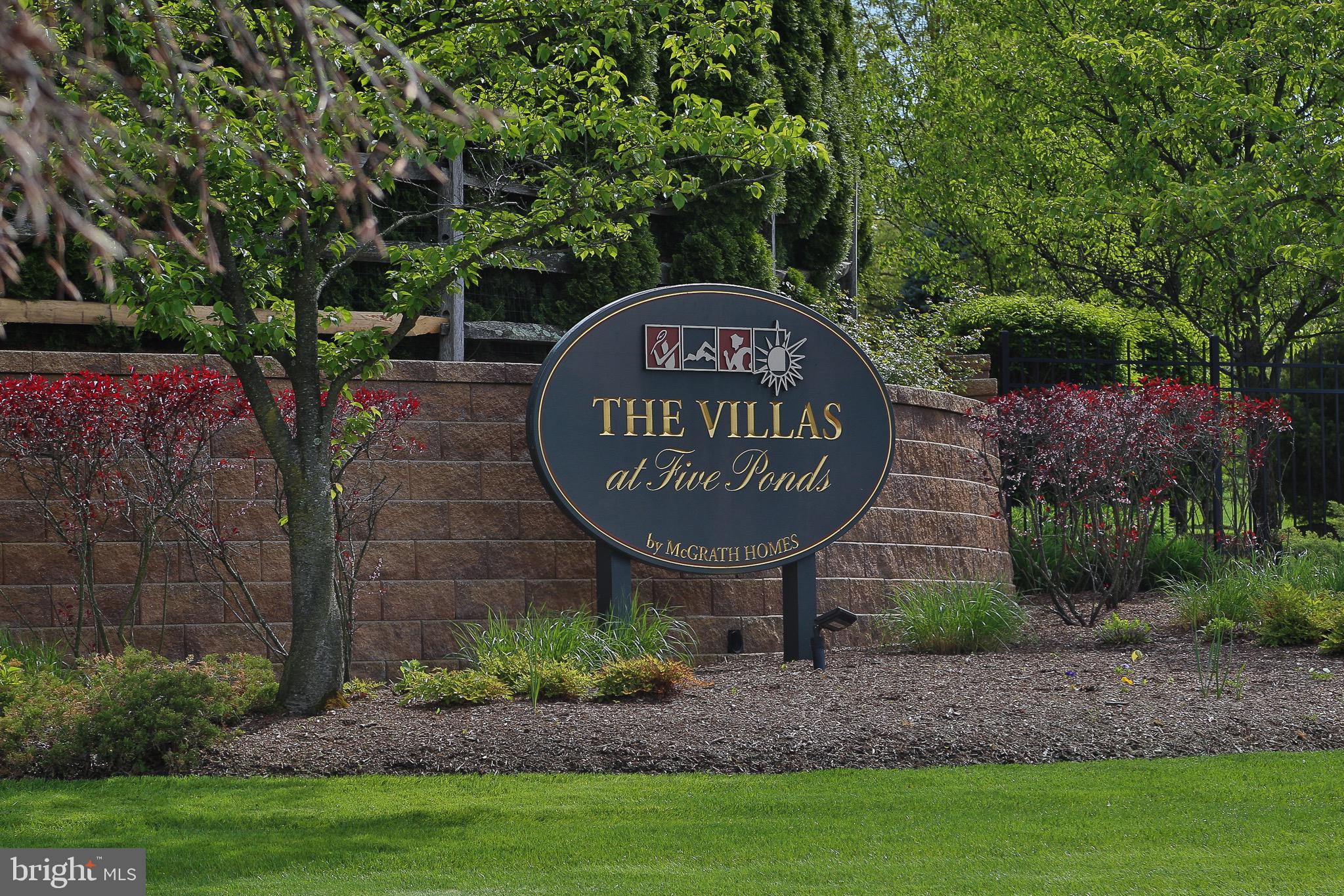 The expanded and upgraded Thornhill model in the highly desirable 55 plus Community, The Villas at Five Ponds is ready for you!  Move right into this beautifully maintained 3 bedroom/3  bath carriage house that has hardwood floors flowing through out the first floor and lots of natural light from the many windows all around. Enter thru the front door and take in the open floor plan with the cathedral ceiling in the living room/dining room combined  as well as the wainscoting all around. Continue into the family room which highlights a cathedral ceiling along with a floor to ceiling stone fireplace and flows right into the upgraded kitchen that provides granite counter tops, breakfast bar with stools, stainless steel appliances,  42" antique white cabinets with undermount lighting as well as plenty of room for a table. In addition to the family room,  a french door opens up into a delightful sunroom surrounded by big windows and a door that takes you out to the large maintenance free deck offering  privacy and views of the large back yard. The primary bedroom located on the main floor has a cathedral ceiling, a big window bringing in lots of natural light and two closets, one a walk in,  that is custom fitted and sits adjacent to the luxurious bathroom where you will find two vanities, a stall shower plus a jacuzzi soaking tub. The second bedroom is generous in size and can be found next to the second full bathroom. Along with access to the two car attached garage is the laundry room on the main floor and  stairs that lead up to the large third bedroom/ office/bonus space along with the third full bathroom. The  walk out basement is only one of just a small number in Five Ponds and would be perfect to finish for additional living space; however there is plenty of storage and there is a small finished area with a window that makes a great office space. Lots of upgrades, beautiful landscaping surrounding the home and plenty of entertaining space makes this home a winner all within the Five Ponds community which  offers plenty of activities and amenities to keep you busy! Pools, tennis and basketball, gym, library, card and game rooms, walking trails plus so much more!! Schedule your appointment today! Don't miss out!