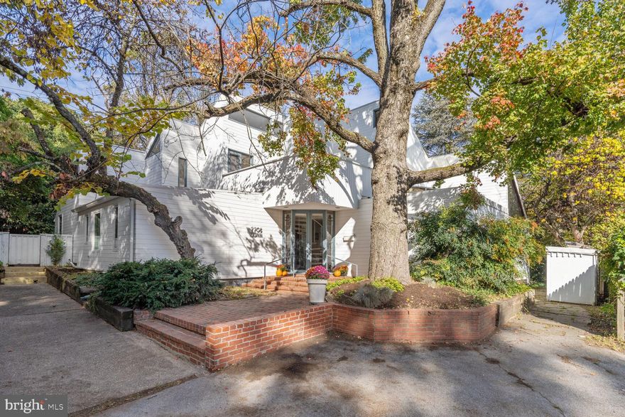 An iconic architectural treasure nestled on a delightful English courtyard on Blackthorn Alley (NO access via Connecticut Ave). Showcased in the April 1969 issue of House & Garden Magazine, this award-winning Hartman-Cox contemporary is bigger and better than ever thanks to subsequent expansions and renovations. The exterior sawtooth silhouette and rounded turret create the aura of a modern-day castle. Inside, a brick-floored entry hall provides a central hub which skillfully connects the public and private spaces. Boasting soaring and slanted ceilings, geometrically shaped clerestory windows, walls of glass, and oversized skylights, the interior is bathed in natural light. This two-level, 4-bedroom, 4.5-bathroom masterpiece offers more than 3000 finished square feet and is inwardly oriented, encircling a phenomenal 30’x 30’ multi-story semi-enclosed courtyard which beautifully expands the living space year-round. Additional interior highlights include an iron spiral staircase, a center island kitchen with original Douglas fir cabinetry, a floor-to-ceiling wood-burning fireplace, a red oak paneled library with built-in bookshelves and a corner mezzanine, a see-through sleeping loft, and a private upper level with balcony access. Outside, the generous .26-acre lot features majestic trees and mature plantings, a greenhouse with decking, a fire pit patio, a lush fenced yard with ample recreation and gardening space, and private driveway parking. Recent exterior improvements include a new GAF Timberline roof and new Boral TruExterior siding. Convenient to downtown Bethesda, the shops at Chevy Chase Lake, several county clubs, and important travel routes, this location is central. Seize this opportunity to own such a rare, architecturally significant gem. **Some photos are virtually-staged**