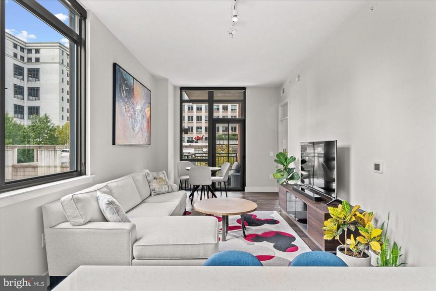 Welcome to your new home at 2000 Clarendon, Arlington, Virginia! Stunning sun-filled,  1 bedroom plus den, the den has a half bath.  This exceptional condo offers the perfect blend of convenience, luxury, and comfort. ✨ Key Features: ✨ Utilities Included: Gas, water, trash, and sewer are all covered.   Amenities: Dive into the community pool, stay fit in the fitness center, and host gatherings at the clubhouse.  Custom Walk-in Closet: Perfect for organizing your wardrobe. 🍽️ Custom Kitchen Cabinets: A chef’s dream come true…featuring quartz countertops, custom 42” shaker-style cabinetry, quality stainless steel appliances and a stunning large costumed island perfect for entertaining 🧺 Full-Size In-Unit Washer and Dryer: Laundry made easy. 🌳 Balcony: Sip your morning coffee or unwind in the fresh air. 11 ft ceiling corner unit with views to Rosslyn skyline and public park 🚇 Proximity to Metro: Just two blocks from the Courthouse Metro station (Silver/Orange lines). 🍽️ Nearby Amenities: Walk to restaurants, bars, grocery stores, gyms, and convenience stores. This condo boasts high-end finishes throughout, ensuring a sophisticated living experience. With its prime location and top-notch features, this condo is an opportunity you don’t want to miss! 📅 Schedule a viewing today The primary bedroom has an ensuite with a large, custom walk in closet. The spacious balcony with southern exposure is everything you would want for outdoor space. This unit also comes with a storage unit and a parking spot in the covered garage. The building is pet friendly and is walking distance to both Rosslyn and Court House metro stops. The building amenities include a pool, gym, and rooftop party room that has expansive monument views.