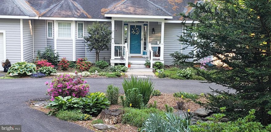 Professional photos coming soon. Nestled within the prestigious Brandywood Estates, this exquisite raised ranch home offers a harmonious blend of warmth and comfort, perfectly situated just steps from the serene shores of the private side of Lake Anna. With 4+ bedrooms and 2.5 well-appointed bathrooms, this residence is designed for both relaxation and entertaining. Step inside to discover an inviting open floor plan that seamlessly connects the family room and kitchen, creating an inviting atmosphere ideal for gatherings. The family room features a stunning fireplace with glass doors and a heatilator, providing a cozy focal point for chilly evenings. The gourmet kitchen is a chef's dream, complete with a central island, ample table space, and built-in appliances, including a sleek electric oven/range, dishwasher, and microwave. The thoughtful design includes a pantry and built-ins, ensuring both functionality and style. Retreat to the sumptuous primary suite, where you'll find a walk-in closet and a spa-like bathroom featuring a soaking tub and a walk-in shower, perfect for unwinding after a long day. The additional main-level bedroom functions well as a bedroom or office. Additional highlights include a fully finished basement with a walkout level, offering two more lake-facing bedrooms providing a delightful retreat for your guests. A recently finished lower-level room could also serve as a bedroom (NTC) or childrens' playroom. The exterior of the home is equally impressive, with beautifully landscaped grounds that encompass nearly an acre of partly wooded land. Enjoy the tranquility of nature from your expansive deck or porch, ideal for morning coffee or evening sunsets. The property features a private, covered boat slip on Lake Anna, complete with an electric hoist and storage, providing direct access to a variety of water activities, from fishing to waterskiing. The attached garage accommodates two vehicles, while the circular driveway provides ample parking for guests. Living in Brandywood Estates means enjoying exclusive amenities such as a boat ramp, gazebo, and common grounds, all while being surrounded by the natural beauty of the lake. This home is not just a residence; it's a lifestyle, offering the perfect blend of luxury, comfort, and outdoor adventure. Experience the best of lakeside living in this exceptional property, where every detail has been thoughtfully curated for your enjoyment.