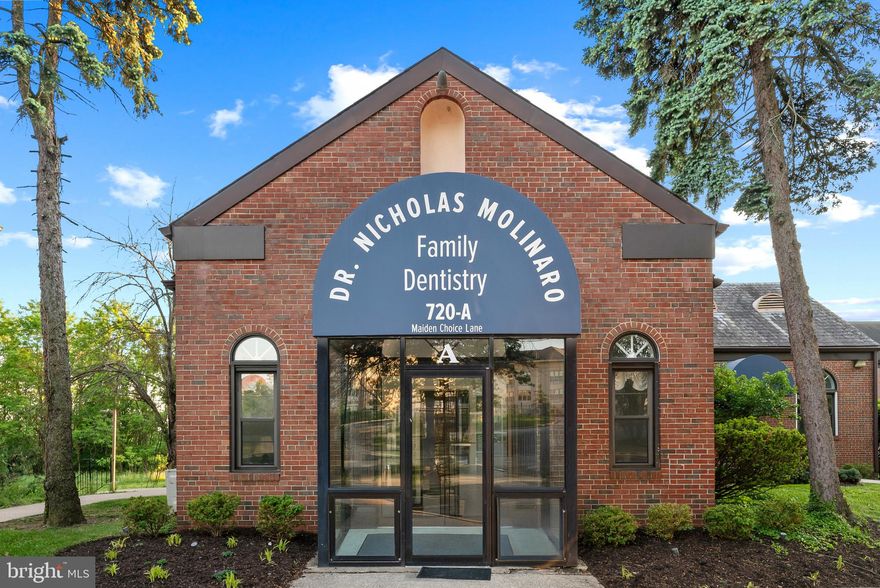Charming brick front lower level commercial condominium offering approximately 5,000 square feet of existing income-producing medical and dental office space in desirable Wilton Springs in Catonsville. This well-maintained property presents an excellent investment opportunity with established professional use, flexible workspace, and a highly convenient location.

Inside, a welcoming lobby features built-in desk areas and window cutouts that create an inviting reception environment. A central hallway with dual water fountains leads to a variety of spacious open work areas, private offices, storage and filing spaces, and flexible-use rooms with bay architecture, making the layout adaptable for medical, dental, or other professional office uses. Additional highlights include two bathrooms, multiple kitchenette areas with cabinets and sinks, and a dedicated break room.

The interior is enhanced by classic chair railing, lower wainscoting, vintage-inspired finishes and wallpaper accents, soft light blue tones, and abundant windows that bring in ample natural light throughout the space. Outside, the property is surrounded by lush landscaping and offers ample parking for employees and clients alike.

Ideally situated near Frederick Road with easy access to I-695, Baltimore City, and surrounding commuter routes, this location combines accessibility, visibility, and long-term investment potential.