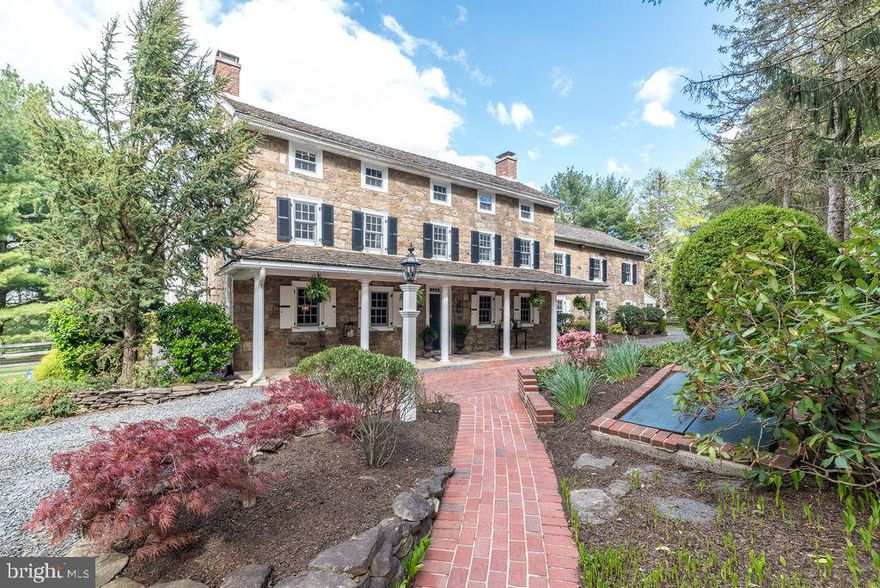 A long-treed lane leads to this extraordinary Circa 1758 Stone Manor elegantly restored to its original grandeur featuring 5 bedrooms, 3 full baths, 2 half baths, 4,278 SF, 4 gas fireplaces, central air, an oversized board and batten style barn/ 2 car garage, 2nd floor loft, workshop, built in cabinets, R-19 insulation and extra storage an additional out building and extra parking. This magnificent home is nestled in a private 2-acre setting with lush gardens, a fenced rear yard, fruit trees, backing to open space blending the stunning architecture with nature that offers a majestic setting. The covered front porch with white columns creates the impressive grand entry. The elegant living room is adorned with gleaming wood floors, deep window sills, exposed beams, a brick fireplace with a beautiful wood mantel and built-in bookcases. The formal dining room is appointed with wide plank wood floors, open beams, deep window sills and a fireplace, perfect for entertaining holiday guests or cozy family dining.  The warmth of the custom gourmet kitchen Kennebec country kitchen features soapstone countertops and farm sink, 5 burner gas stove, new microwave, deep window sills and the back staircase.  The family/great room overlooking the tranquil, picturesque setting is filled with natural sunlight, a cozy brick fireplace, an original field stone wall and a French door entry to the patio. The patio offers an open gas fireplace and a wonderful place for entertaining, a summertime barbeque, a relaxing place to read your favorite book or simply relax and view the tranquil setting. The sun room entry leads to an area with built- in cubbies and  2nd powder room. The 2nd level features the spacious primary bedroom accented with deep window sills, a walk-in closet, an additional closet, the primary bathroom and the back staircase.  There are 2 additional bright and airy bedrooms and a Jack and Jill bathroom. The 3rd bedroom has a fireplace and 2 double closets. The 3rd floor offers two adorable bedrooms, a full bath and extra closets. The laundry room is located on the 1st floor, includes a custom wood cabinet with a beautiful copper hammer sink, closet and tile floor. This meticulously maintained residence includes a basement and gas heat 2 zoned central air. Conveniently located with easy access to the major highways, PA Turnpike, train to center city, shopping and restaurants. Sought after Hatboro Horsham school District. This is a wonderfully warm and inviting place to call home.