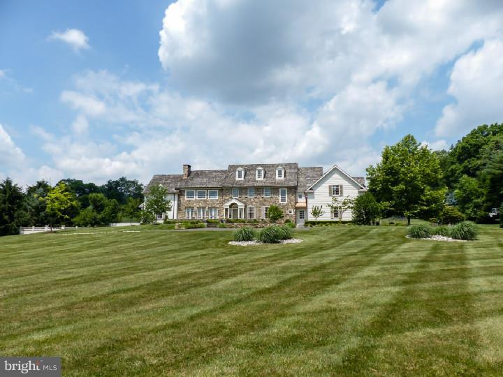 Quality, care, taste and luxury are the keywords to describe this wonderful home which boasts over eleven thousand square feet of living space, and amazing outdoor living spaces.... a country stone manor house located in a small enclave of very prestigious homes in the heart of Solebury. This stone manor home reflects Old World architecture blended seamlessly with New World convenience. Understated elegance exudes throughout this 10,735 sq ft home with 5 bedrooms, 5 full & 2 Half baths. One of a kind, designed by Ralph Fey Architect. 2-story great room with Rumford fireplace, European plaster cast ornamental surround, sunlit with oversized French doors to verandas. Custom kitchen, distressed wood cabinetry with nickel hardware, commercial grade appliances, granite counter, oversized center island with reclaimed antique older wood counter, and hammered copper sink. Cathedral breakfast room and adjacent hearth room with wood burning fieldstone fireplace. Full, finished lower level features full kitchen, full bath, billiards area, media room, professional gym, and second laundry. Bluestone terraces, fountains, boxwood gardens, and a stunning pool complex with summer kitchen. Magnificent!