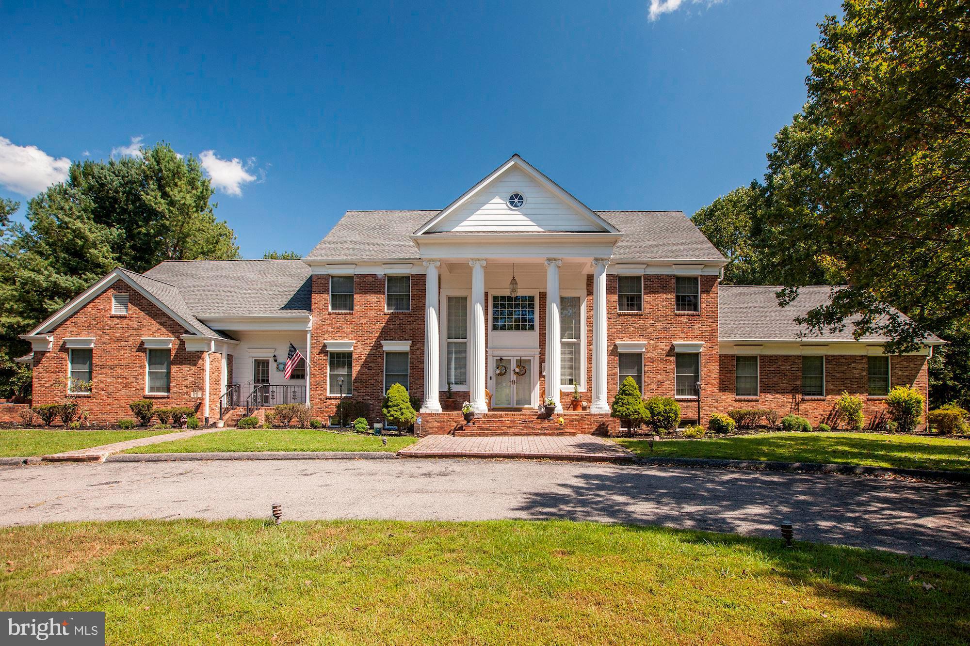 Incredible home set on over three acres of privacy! Marble floors in foyer, hardwoods for rest of home. Extremely detailed tin ceiling and trim. The floor plan is open and has beautiful sliding glass doors along back of the home. Brick, enclosed deck with wrought iron rail overlooks a grand backyard. The private level includes a master suite with wood burning fireplace, luxurious bath and three closets! Perfect for homeowners who appreciate exquisite craftsmanship!
