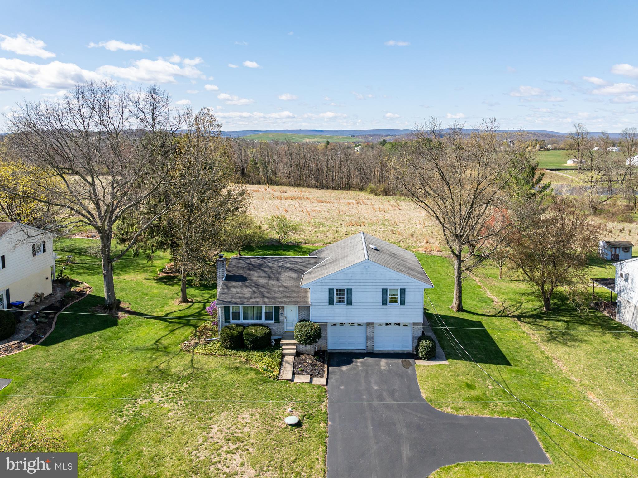 This well-maintained split level located in a peaceful country setting. The home has been lovingly cared for over the years and is ready for you to add your personal touches to truly make it your own! Step inside to the living room with an expansive picture window that fills the space with lots of natural light. The layout seamlessly connects the kitchen and dining room, perfect for everyday living and entertaining. The kitchen features plenty of cabinets and stainless-steel range and refrigerator. There are three generously sized bedrooms, including the primary bedroom with powder room. The hall bath is spacious and has a built-in vanity and laundry area with a washer and dryer included. The lower level has a large family room with a charming beamed ceiling and a wood-burning brick fireplace, an ideal space to relax or gather with family. An Additional room in the lower level offers great potential as a workshop, craft room, or gym. The home has a water treatment system and central air. The oversized two car attached oversized garage offers plenty of space for your vehicles and your tools. Outback, enjoy the large, flat backyard for gardening or play. This great home is located in a quiet neighborhood! Don’t miss out!!