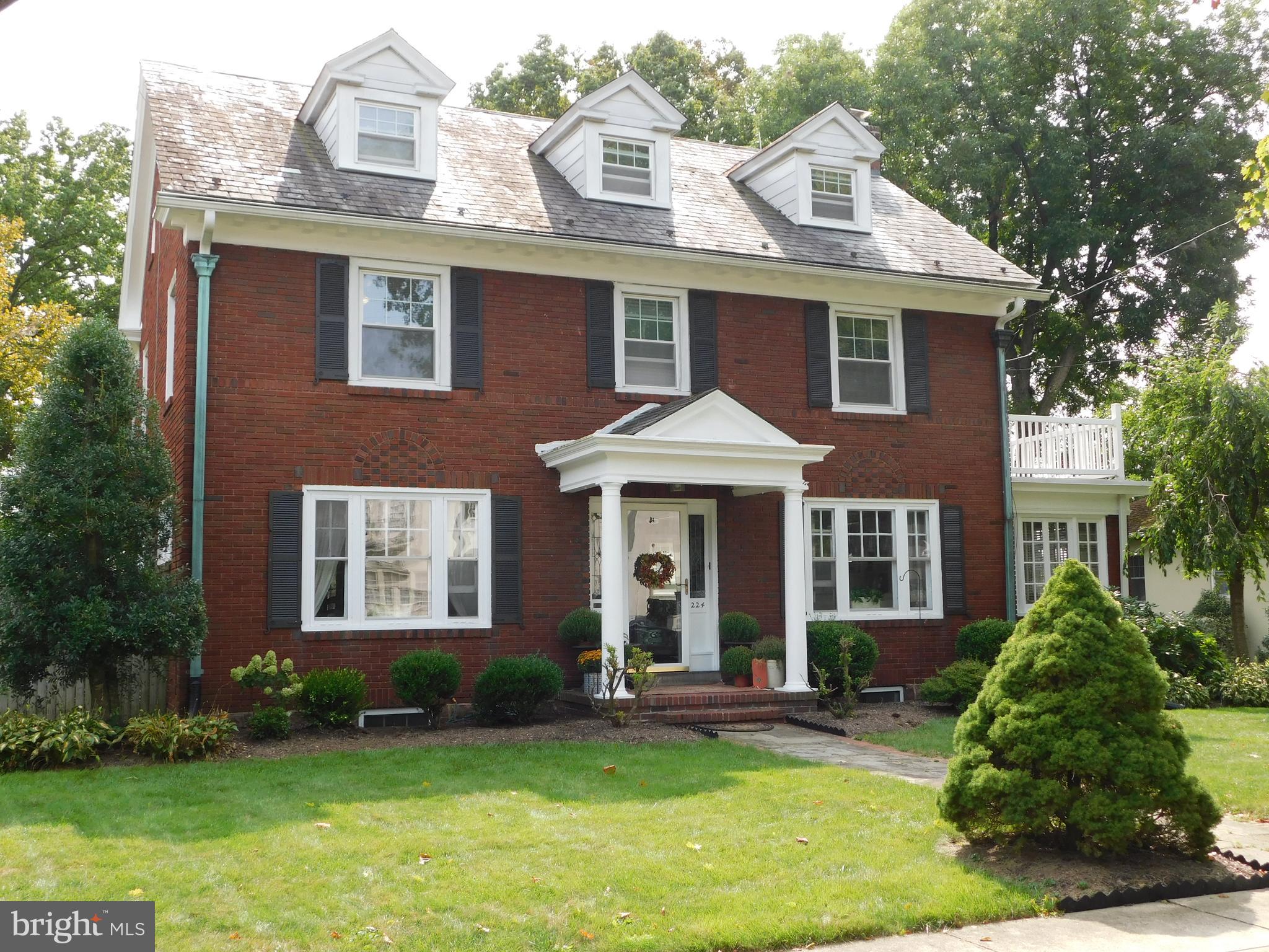 The charming Rosedale Community is where you will find this enchanting brick colonial home, loaded with charm and character.  Three finished levels include over 3500 square-feet of beautiful living space. A flagstone walkway leads you into this center hall colonial with hardwood floors. The western side of the house is made up of a living room which includes a brick fireplace with wood molding surround and mantle. Double French doors give you entrance into the side sunroom area with lots of natural light.  The eastern side of the home includes the formal dining room and the large eat-in kitchen area. The kitchen boasts tile floors, cherry cabinetry, stainless steel appliances, dining area, and built in desk. A powder room and first floor laundry room with sink finish up the main living area. The second floor includes 4 bedrooms, separate sun-porch room, and full bath. The upper level includes 2 more spacious bedrooms as well as another full bath with a claw foot tub. The exterior is beautifully landscaped with a recently reconfigured rear deck, detached garage and off street parking that is off the rear alley. Also included is economical gas heat, central air, upgraded 200 amp. electric and much much more!