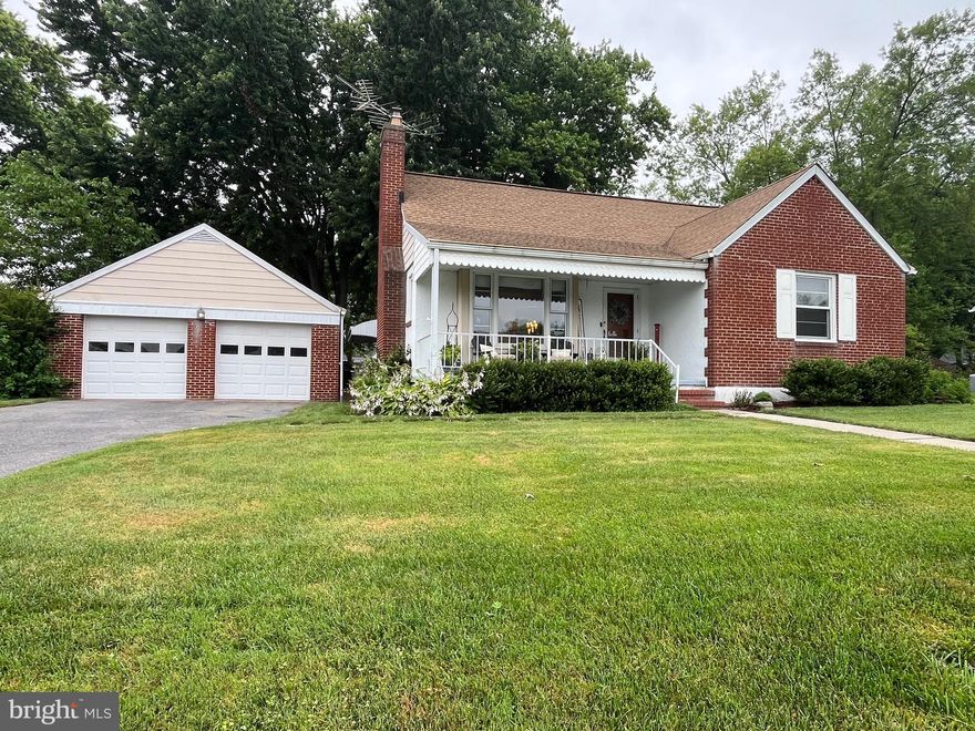 Brick, 4 bedrooms, 2 plus baths oversized garage with 3 overhead doors, auto garage door openers and pull down steps for additional storage. .39 Acre lot with huge back yard. Oak floors were refinished 2 years ago. Updated kitchen with granite counters and all wood and or quality plywood with  soft close drawers and doors, trash and recycling bins are hidden in the cabinetry. 2 updated full baths  with heated floors. Main floor bathroom was updated last year, which features blue tooth speaker in the fan and  2 medicine cabinets with outlets inside- great for electric razors and toothbrushes! Main floor closets have built in shelving. Gas heat  and water heater. Water heater is 4 years old.  Central A/C  is 4 years old and zoned separate. Brand new mini splits for upper  bedrooms and baths. Brand new floors on 2nd level. Basement with wine cellar and rough in for full bath .Basement has been waterproofed with a lifetime transferable warranty. Flower beds have drip irrigation, also available for potted plants and flowers. Pella windows. All updates are 4  years or less.  Masonry fireplace with glass doors. Covered front and rear porches and patio.  You will love all the built ins and custom moldings through out!!!!